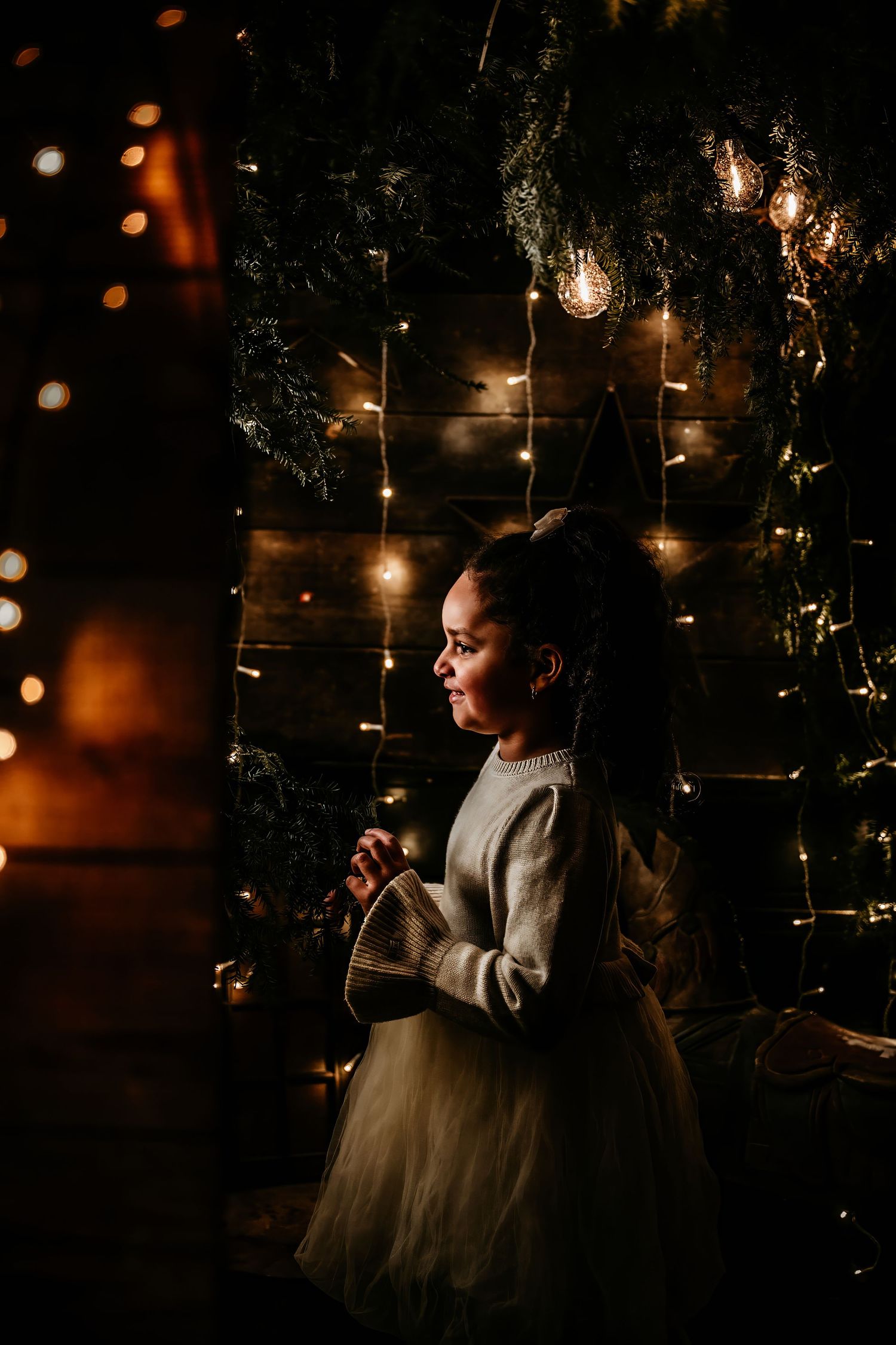 Moody nighttime scene with string lights and silhouettes creating a dreamy, romantic atmosphere.