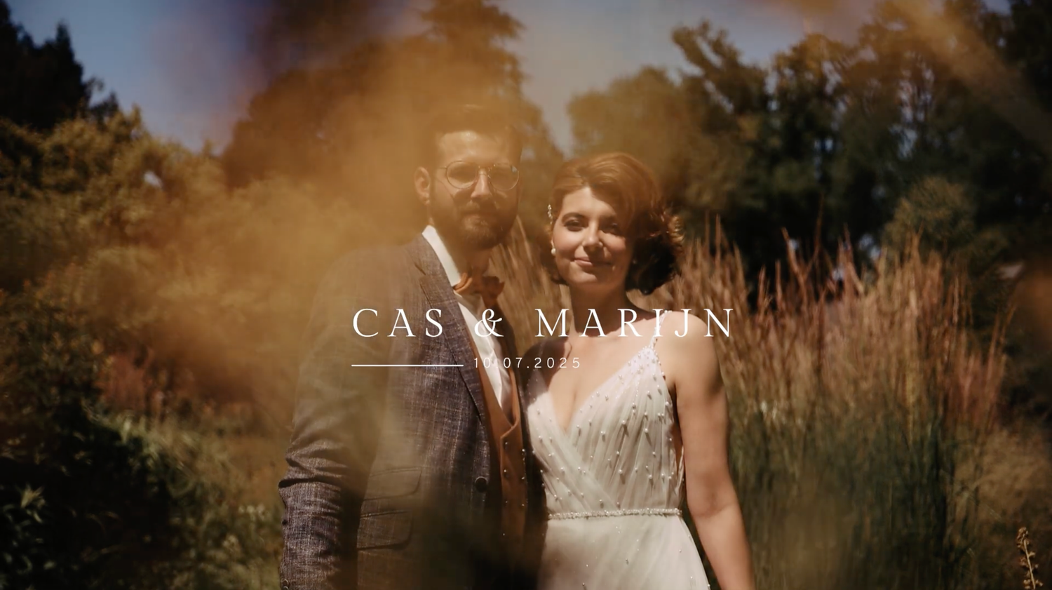 A romantic wedding photo shoot in a golden field at sunset with soft natural lighting and tall grass.