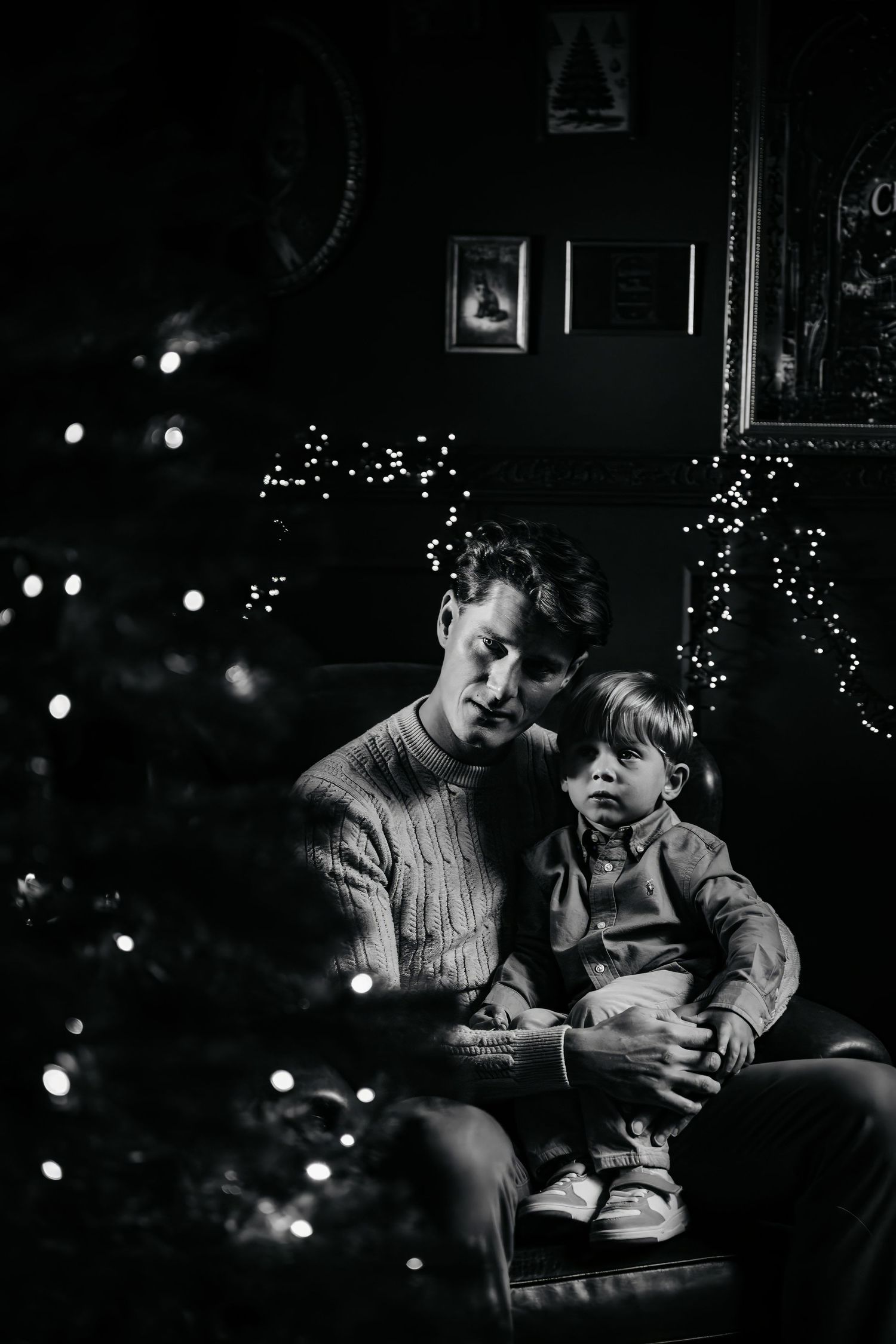 A black and white photo series showing intimate moments between parent and child on a couch with Christmas lights in background.