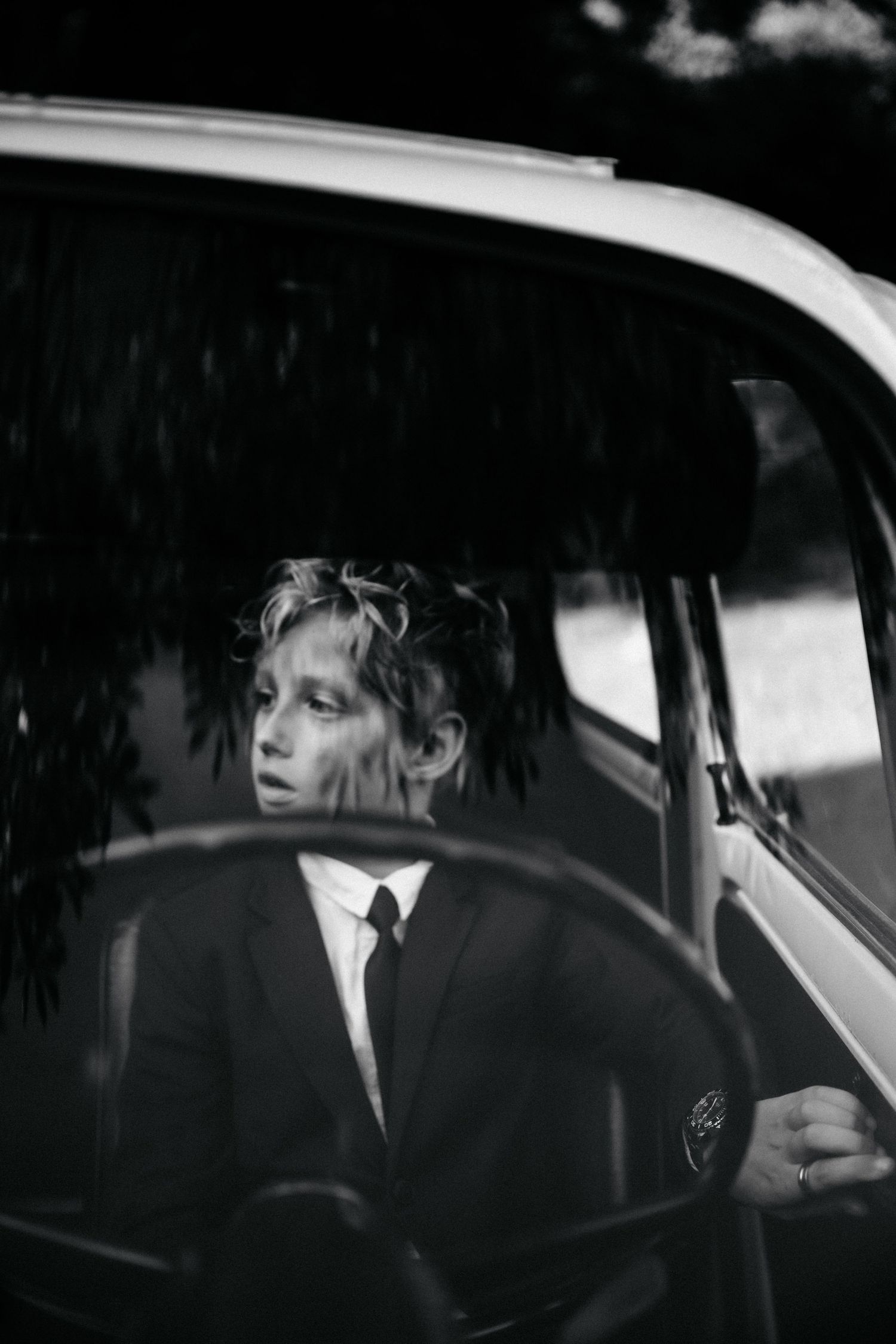 Black and white vintage-style photos showing silhouettes through classic car windows.