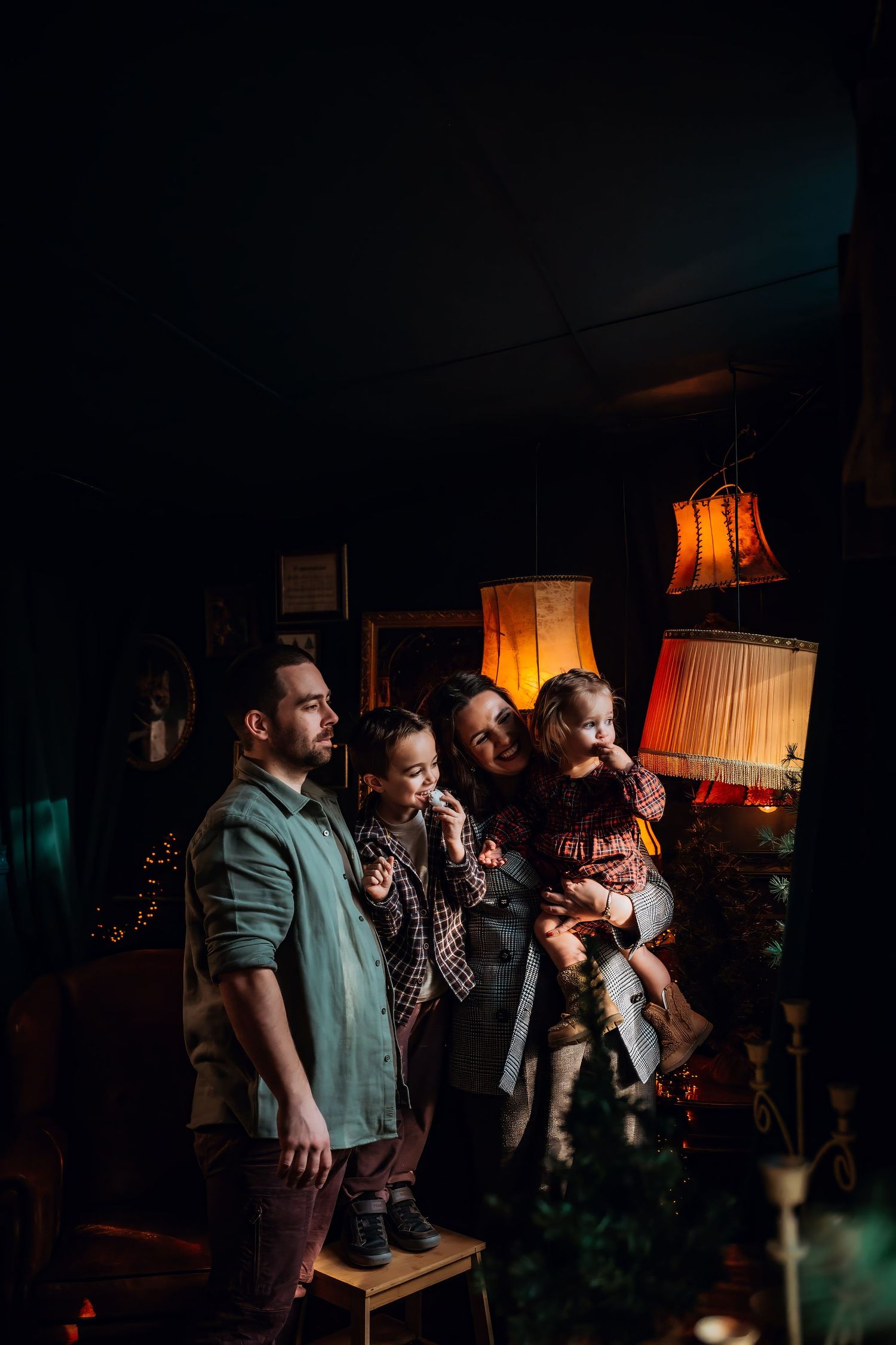 A group of performers singing together on a dimly lit stage with warm lighting in the background.