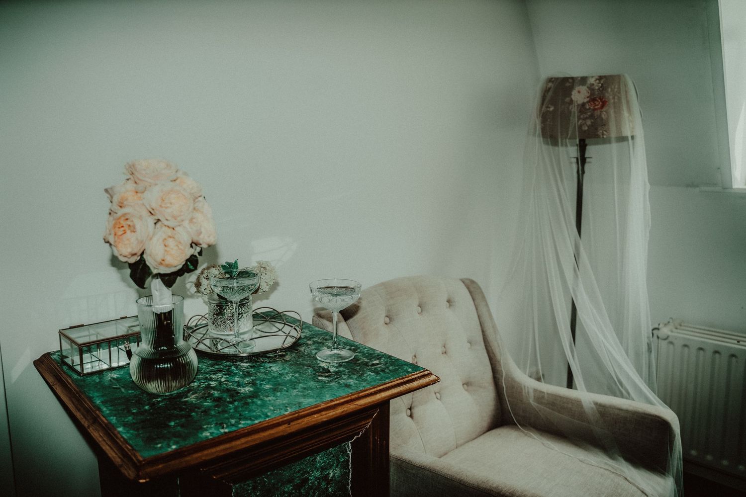 A dreamy teal-tinted photo collage showing a bedroom interior with flowers and furniture in soft lighting.