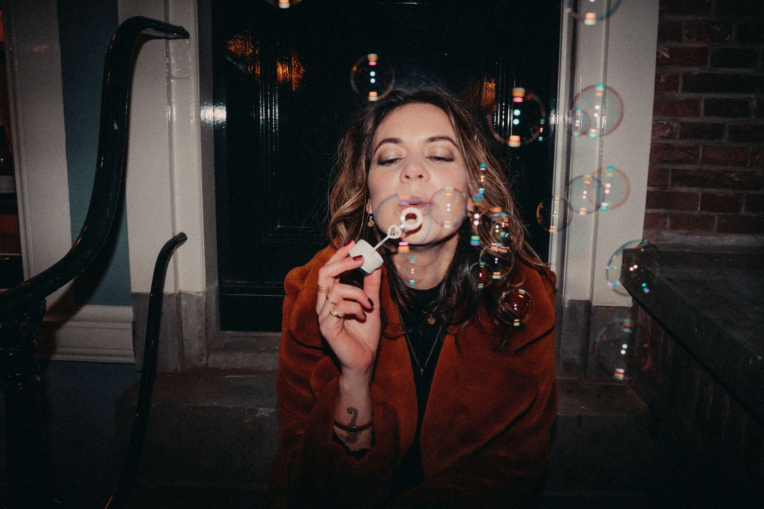 A series of dark moody portraits showing someone smoking in dramatic red lighting and shadows.