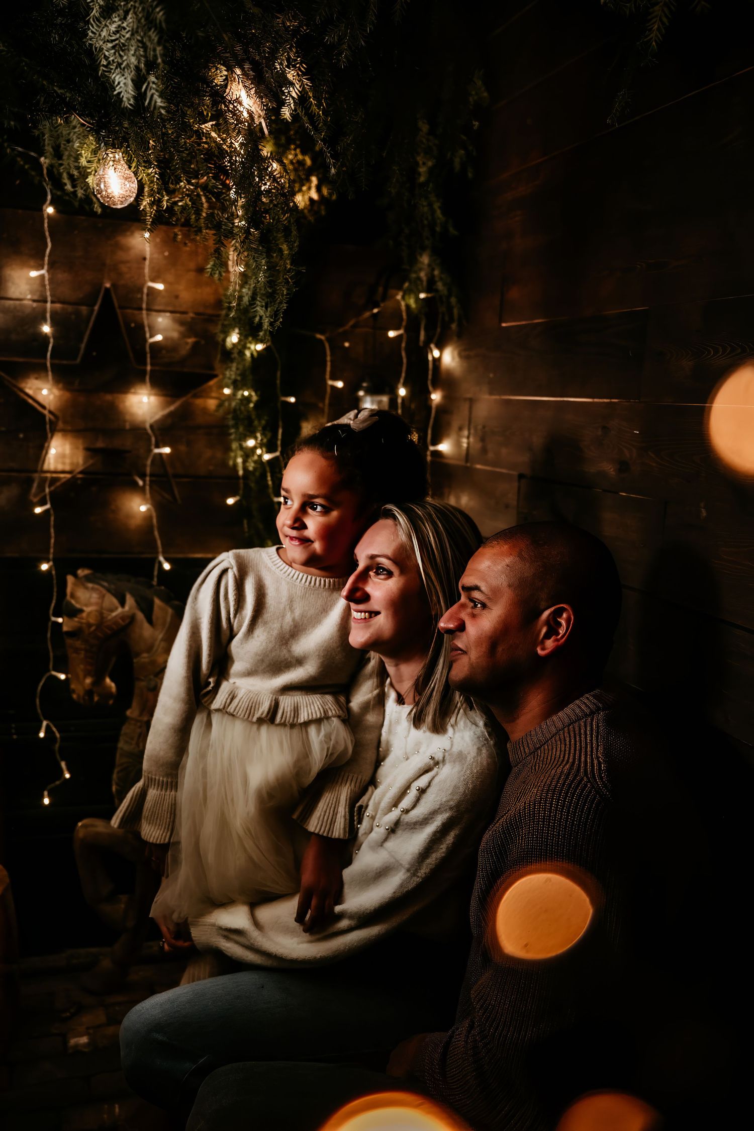 Cozy indoor gathering with warm lighting and string lights creating an intimate atmosphere.