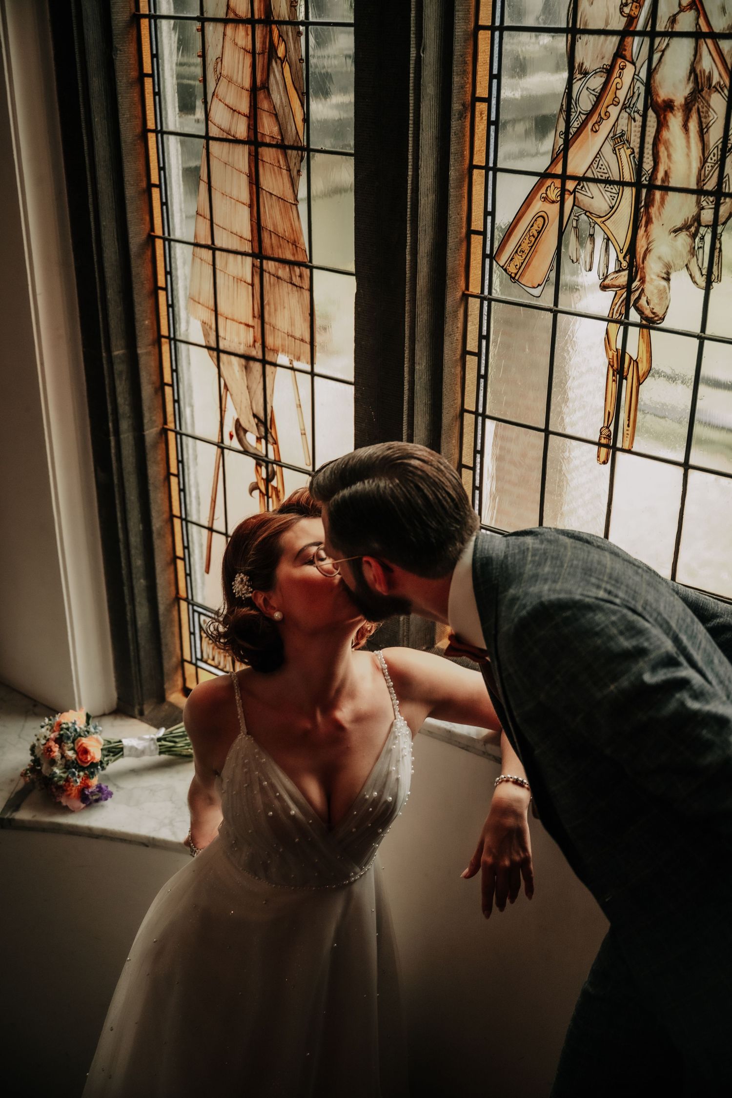 Artistic sequence showing a couple in an intimate moment by a window with stained glass details.