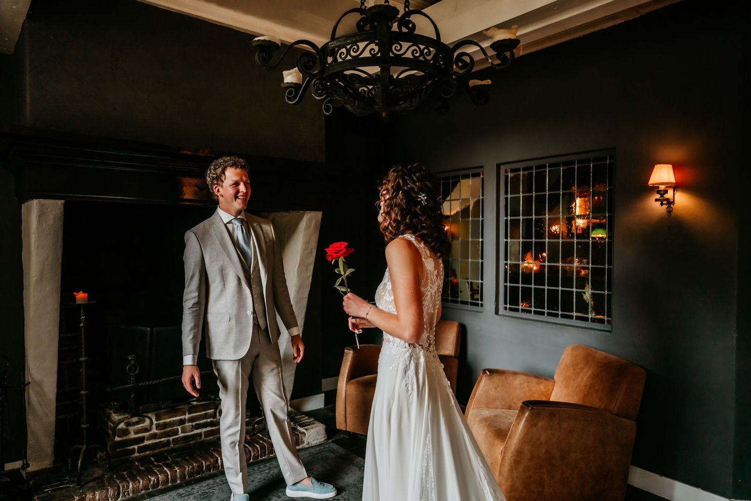 Couple dancing intimately in a dimly lit room during their wedding reception.