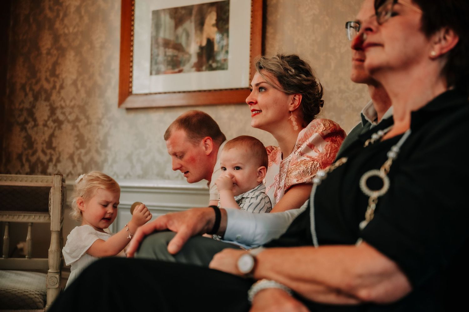 Wedding guests watching intently during an emotional ceremony moment.