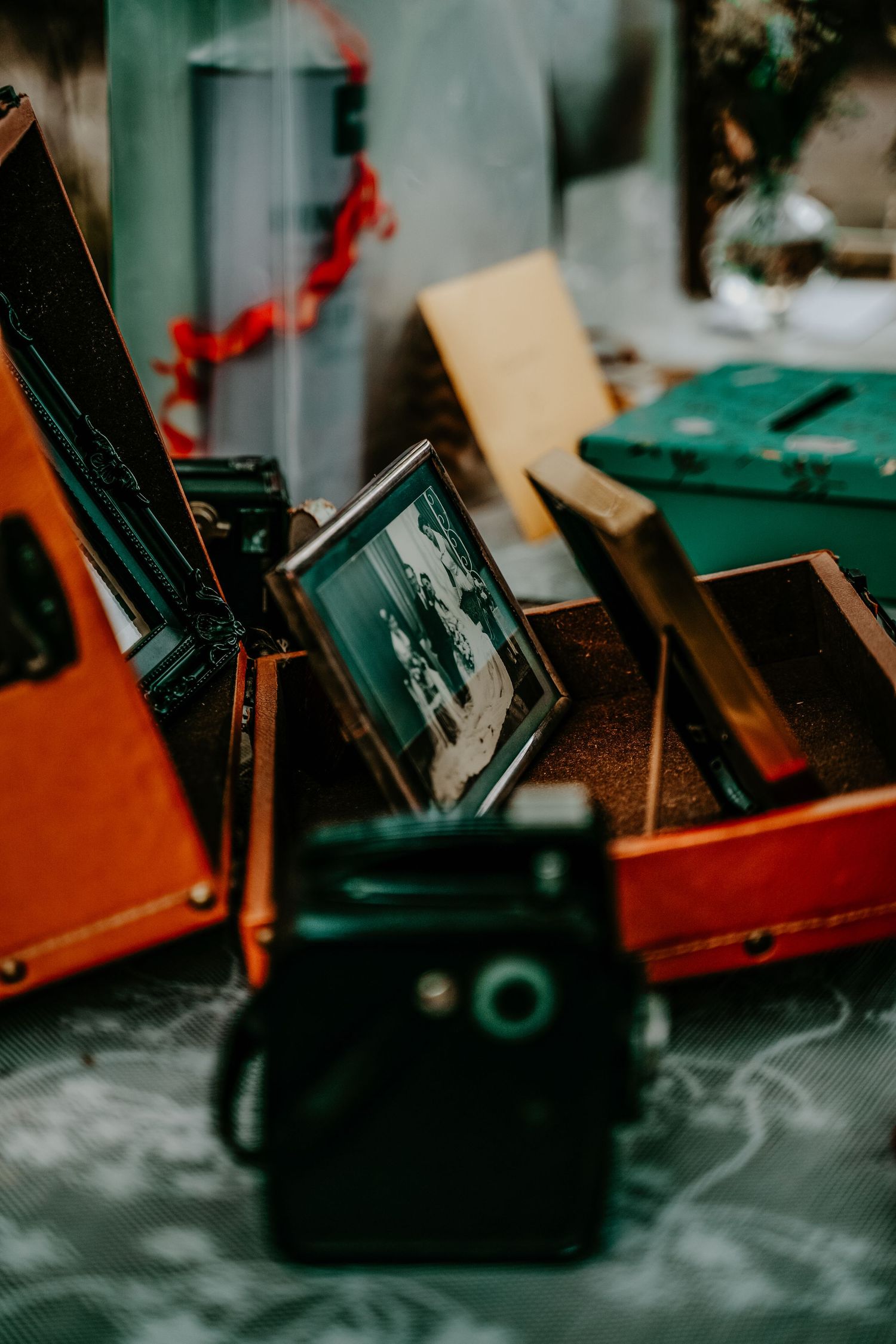 Vintage photographs and memorabilia displayed in wooden boxes with a retro camera in the foreground.