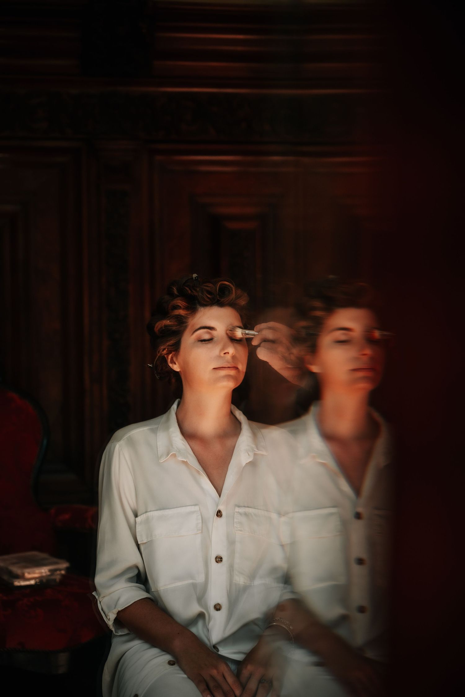 Artistic black and white portrait showing a dramatic double exposure effect with a white collared shirt.
