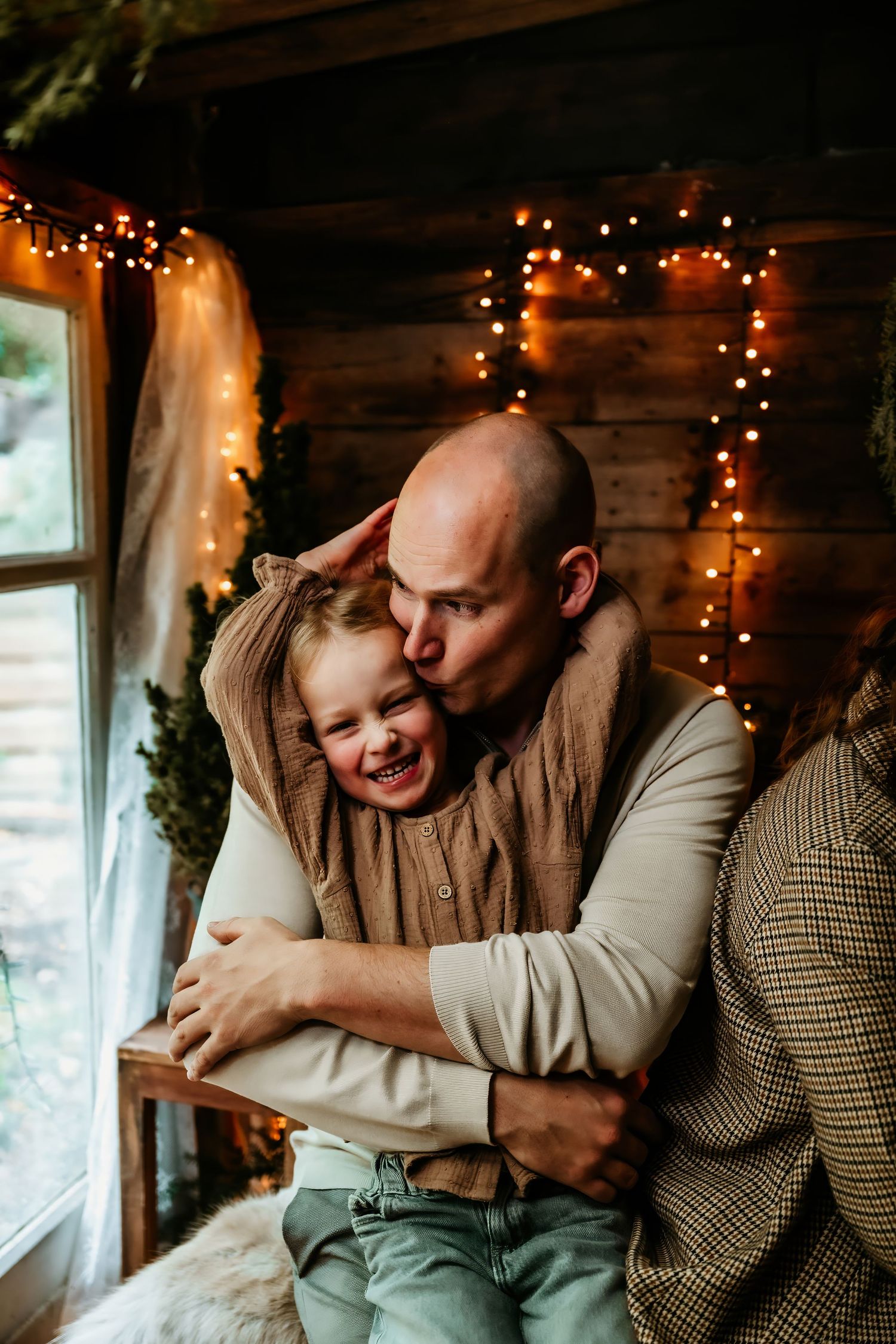 Romantic couple sharing intimate moments in a cozy room decorated with warm string lights and rustic decor.