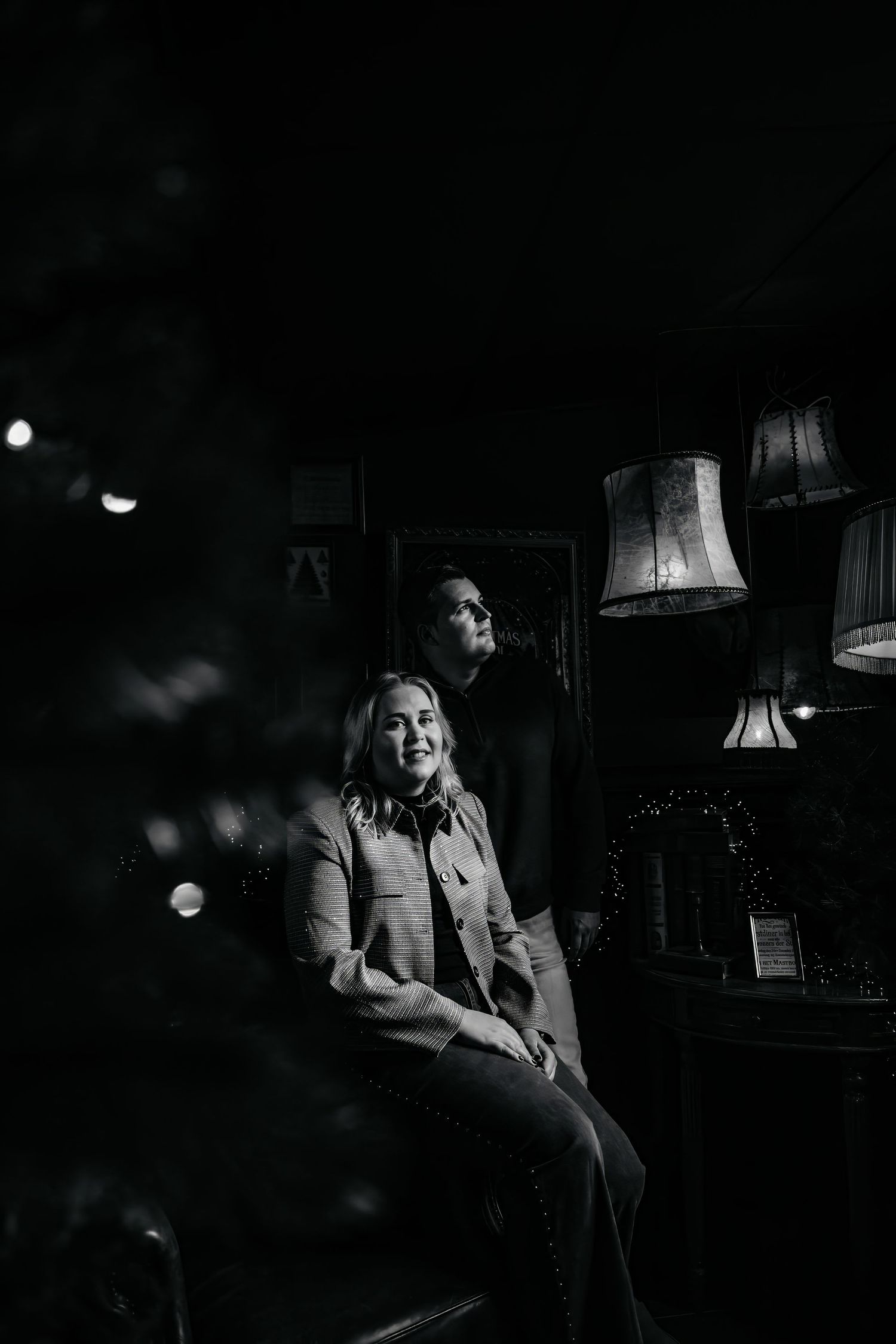 A moody black and white photo series showing someone smoking and relaxing in a dimly lit room.