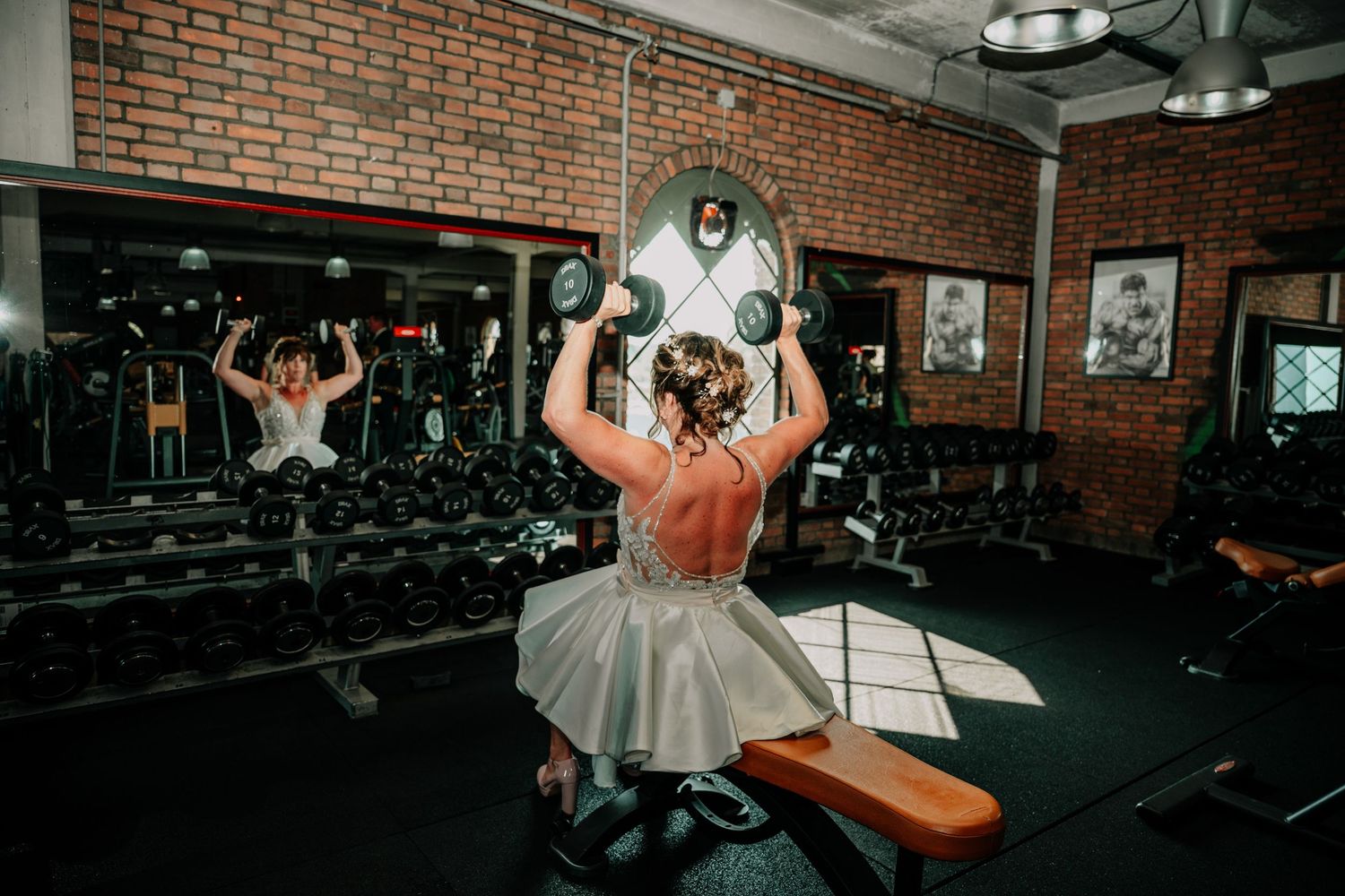 Sequence of shots showing a workout routine being performed at a brick-walled gym with exercise equipment and lighting.