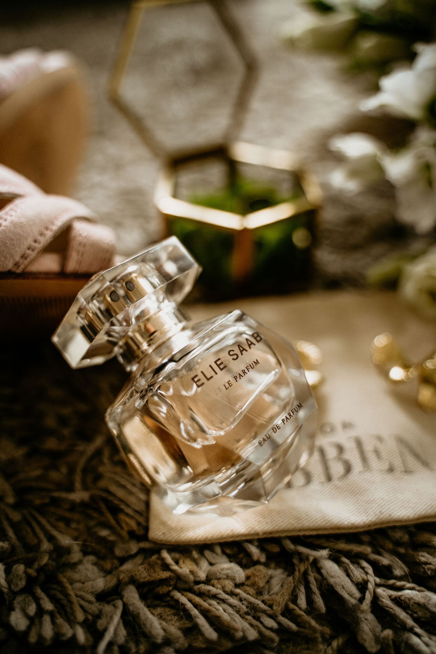 Close-up details of elegant perfume bottles arranged artistically in sepia tones.