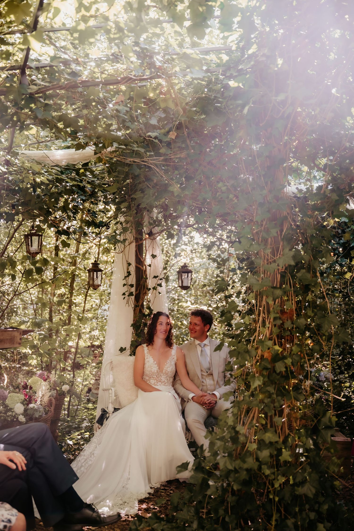 Romantic garden wedding scene with lanterns and floral decor creating an intimate outdoor setting.