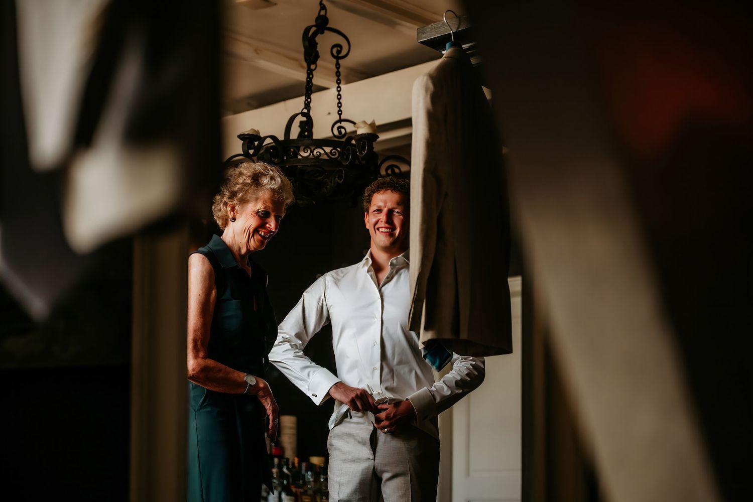 A series of black and white photographs showing candid moments at a wedding celebration.