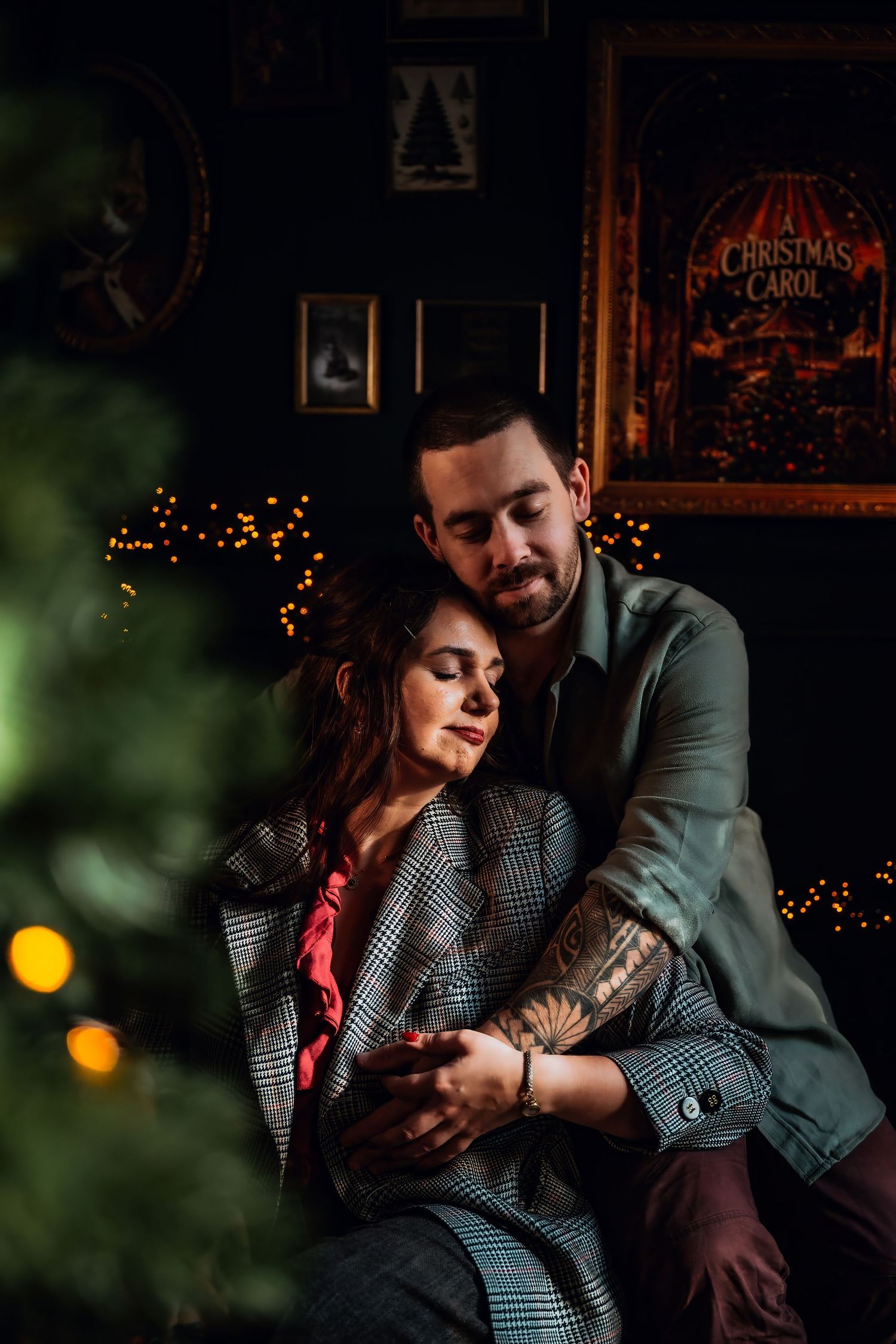 A romantic couple shares intimate moments in a dimly lit setting with twinkling Christmas lights in the background.