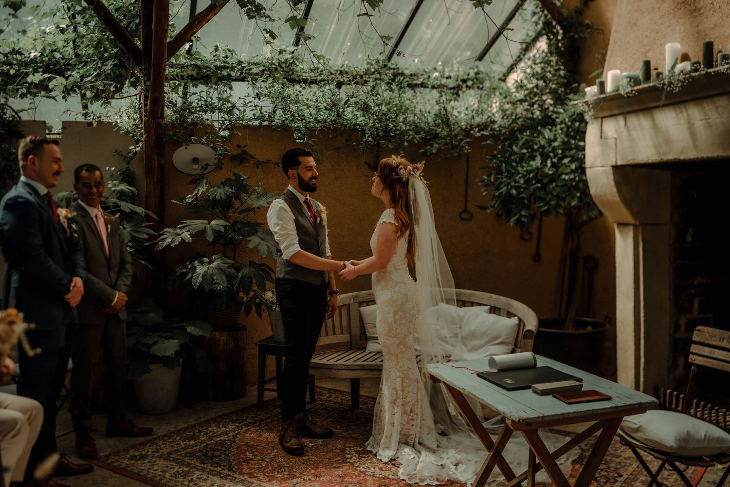 Intimate garden wedding ceremony with white chairs and natural decor.