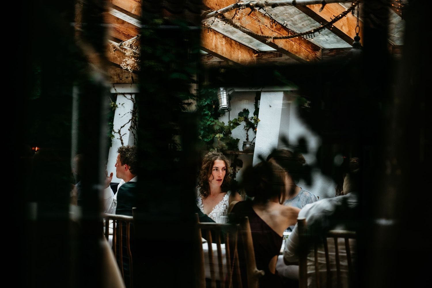 Moody interior shot of a wedding reception venue with natural light streaming through windows.