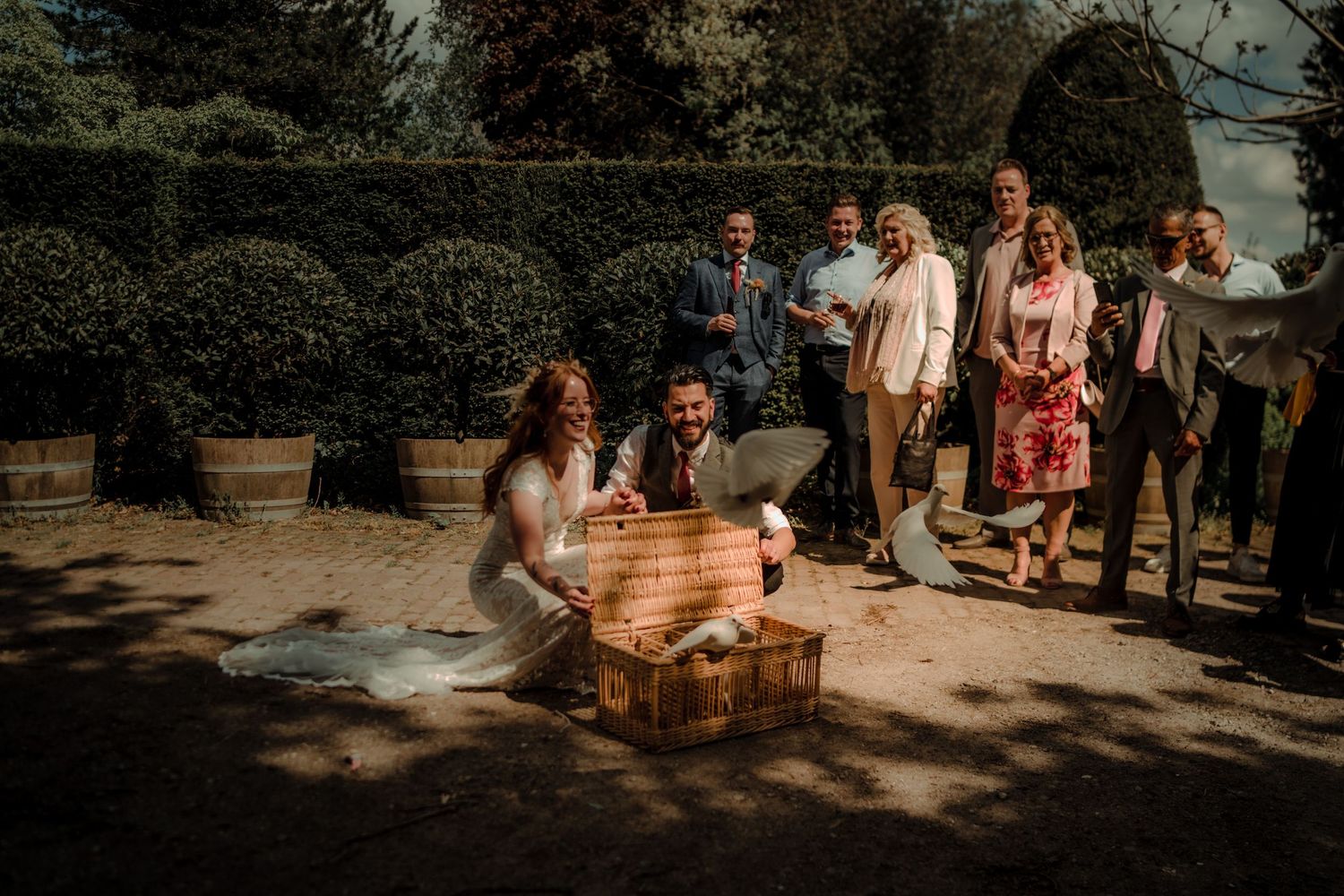 Wedding celebration in garden setting with wooden box centerpiece.