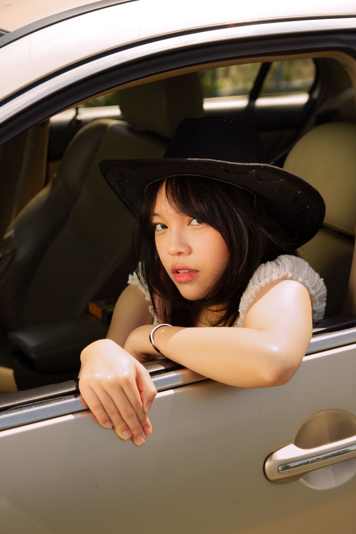 cowgirl looking out of the window of her vintage car
