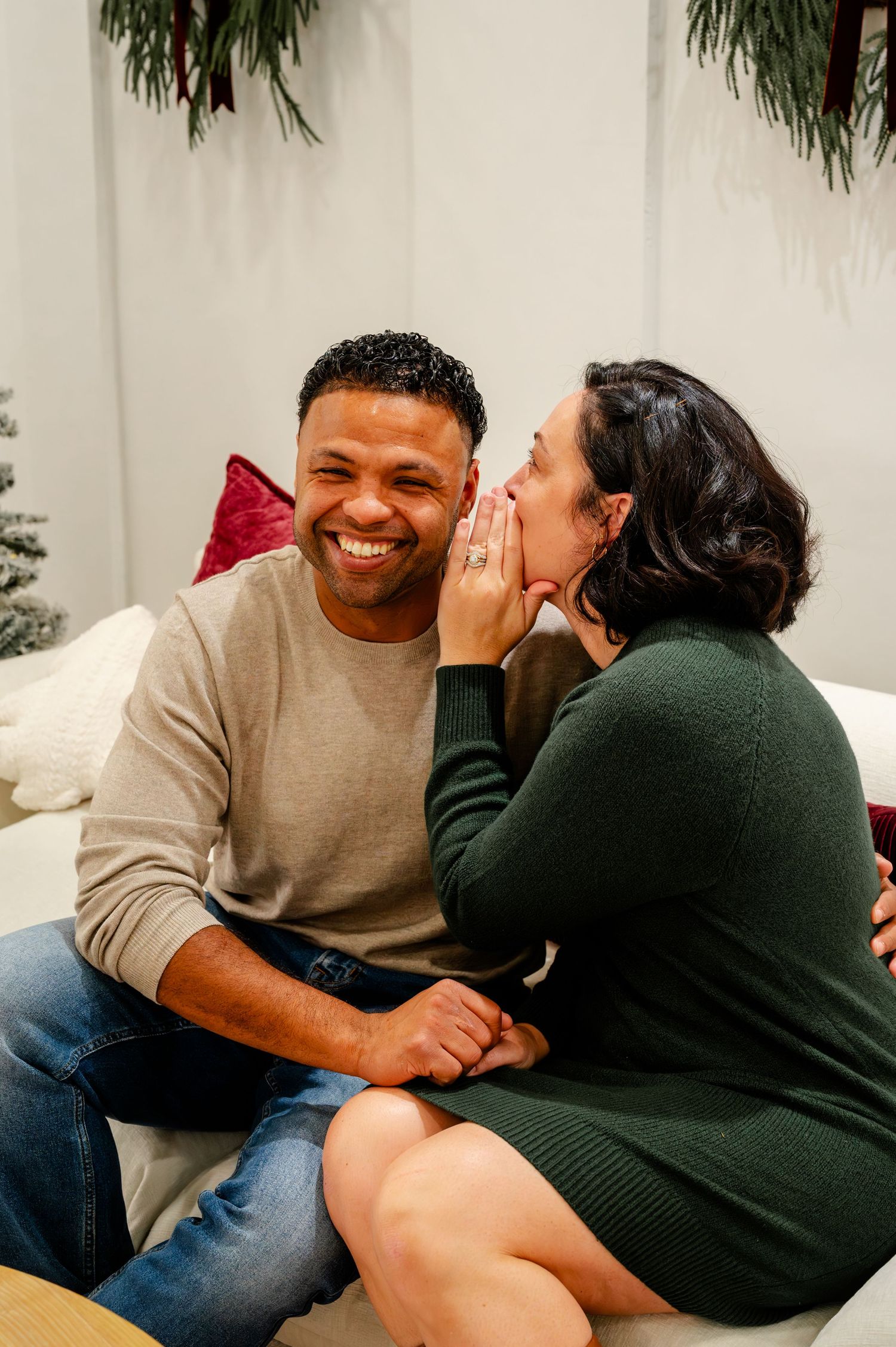 A couple shares intimate moments and laughter while sitting together on a couch in a sequence of candid photos.