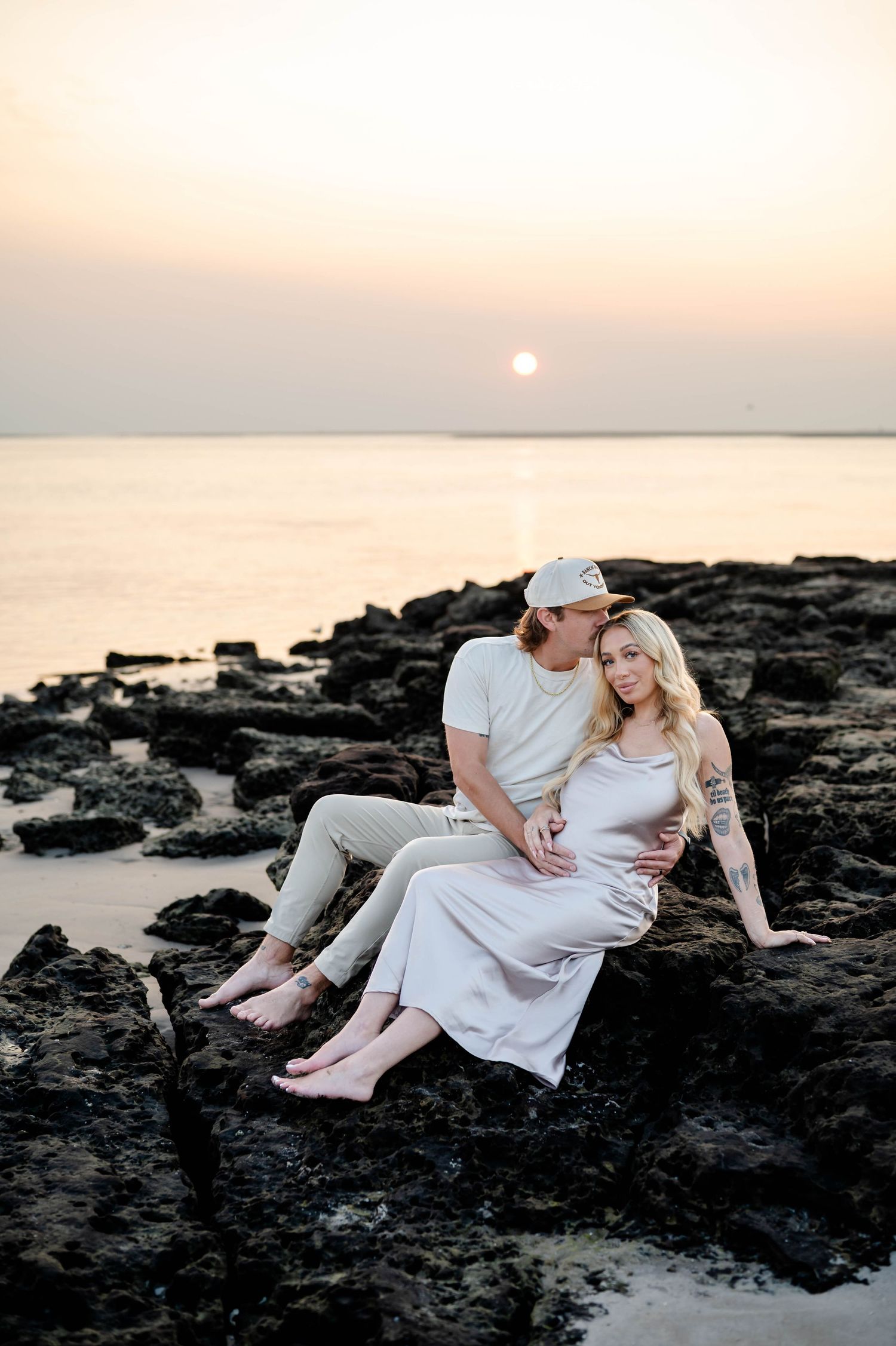 A romantic sunrise maternity photoshoot on Black Rock Beach in Jacksonville by the ocean.