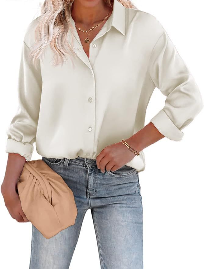 Classic white button-down blouse with collar and long sleeves paired with jeans.