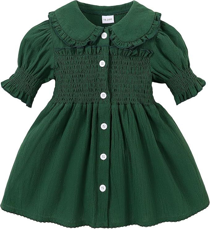 Green smocked baby dress with ruffled sleeves and button front closure.