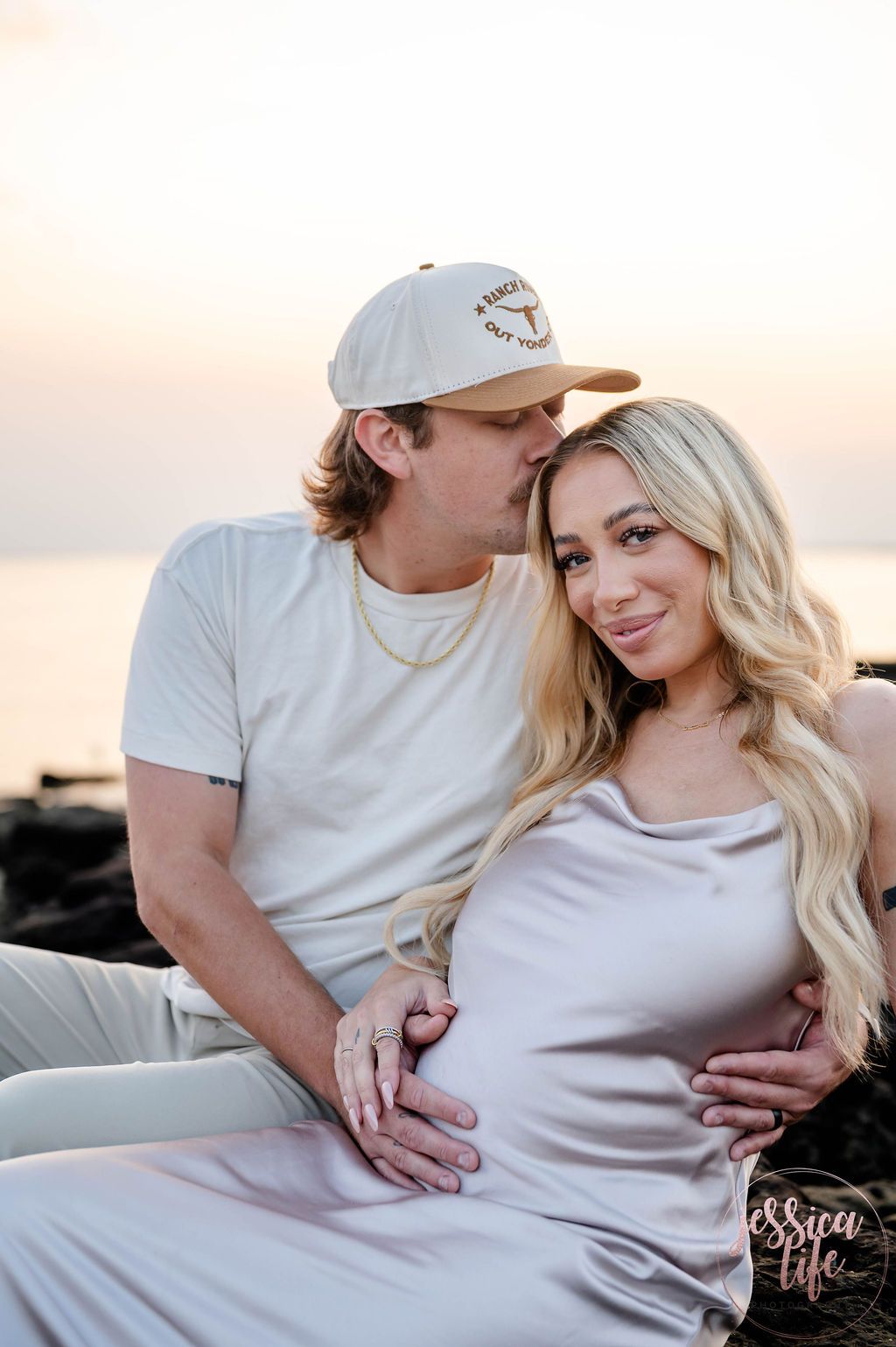 Intimate maternity photos taken at sunrise by the ocean.