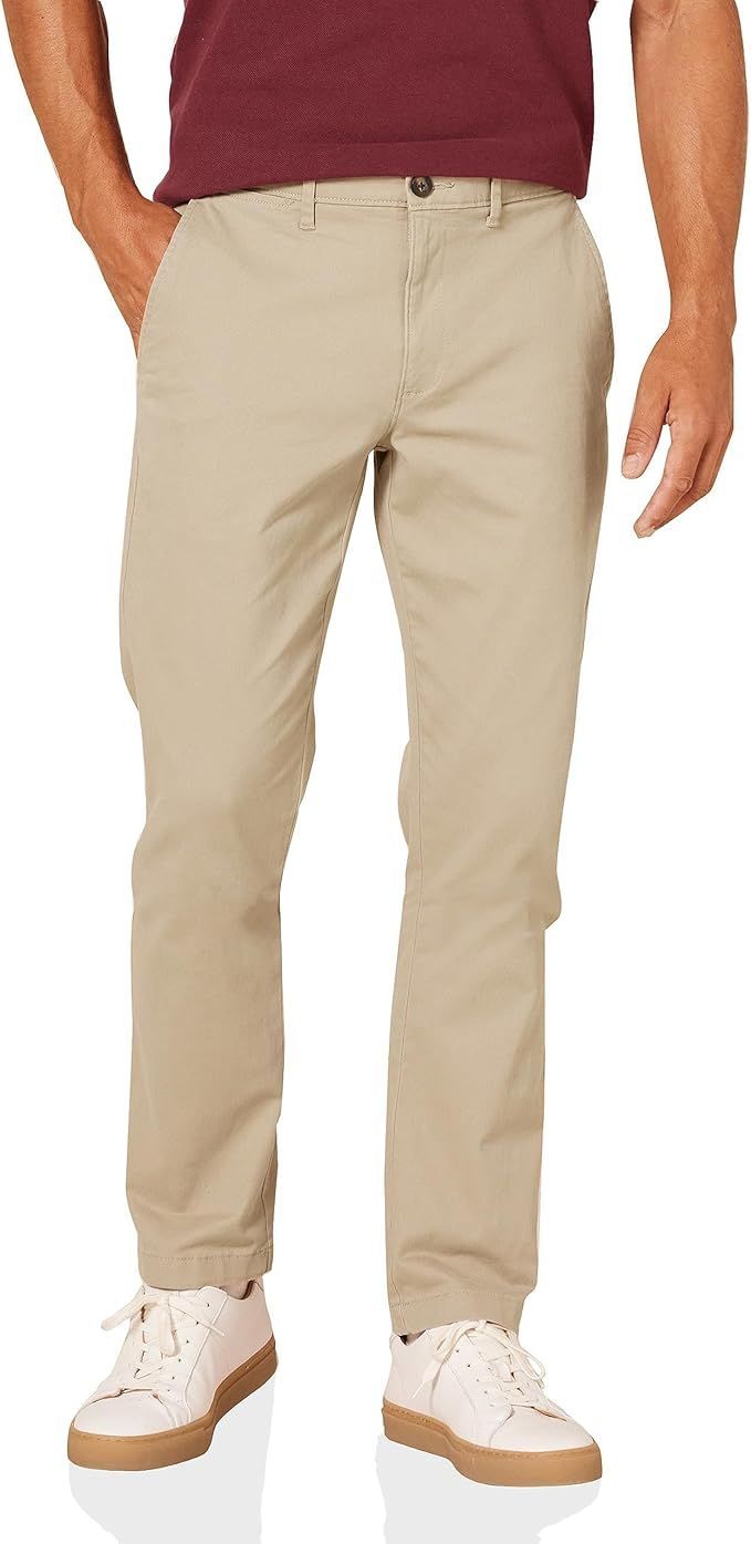 Beige chinos with burgundy top and white sneakers shown from waist down.
