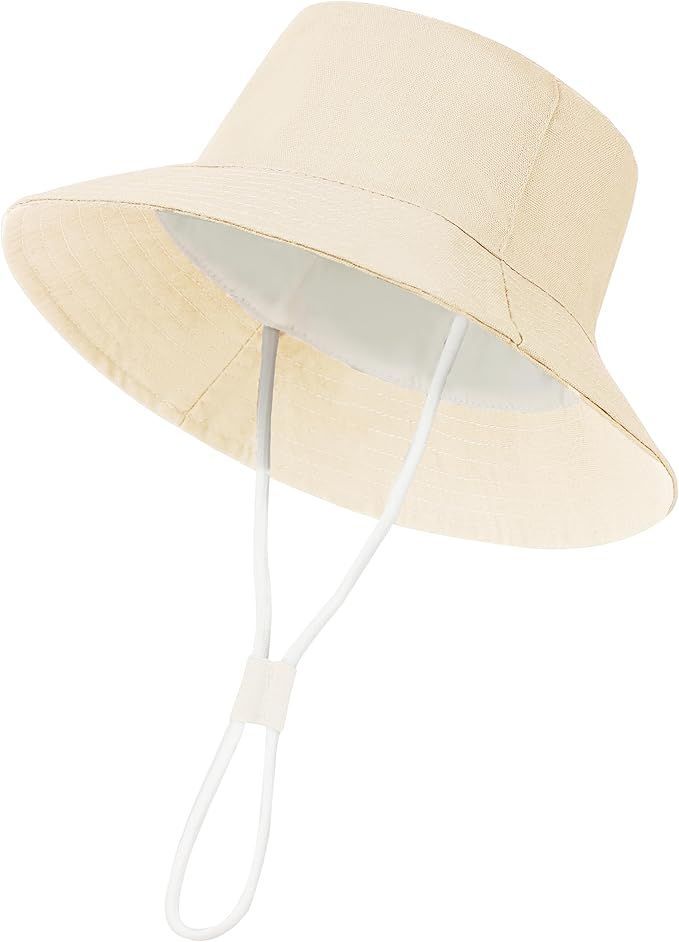 Beige bucket hat with adjustable chin strap cord for sun protection.