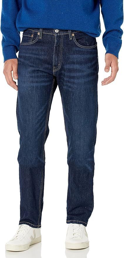 Dark blue denim jeans with white sneakers shown from different angles.