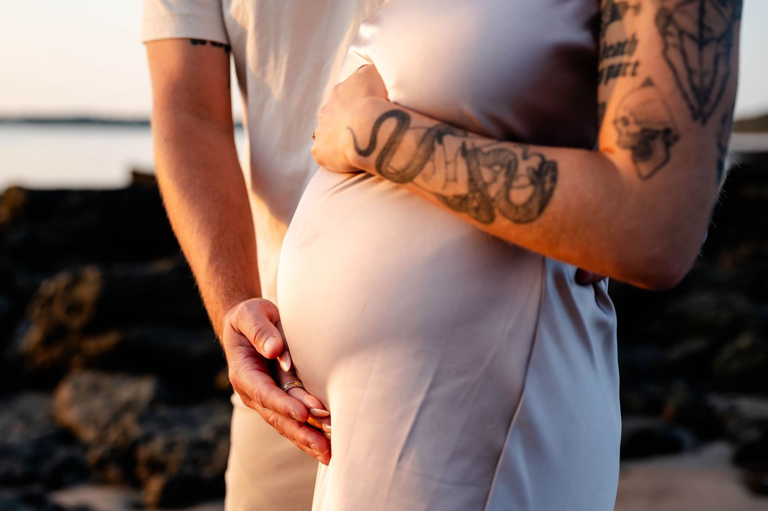 Side view of pregnant belly - sunrise maternity Jacksonville beach photoshoot.