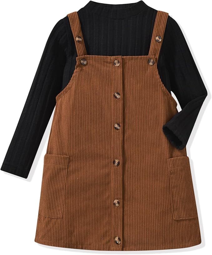 Brown corduroy overall dress with button front and black long sleeve undershirt.