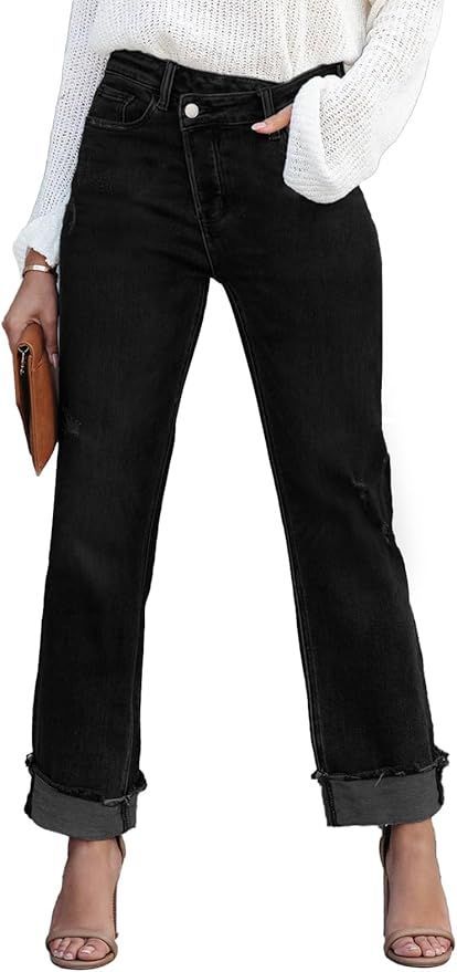 Black straight leg jeans with cuffed hems and distressed details paired with a white knit sweater.
