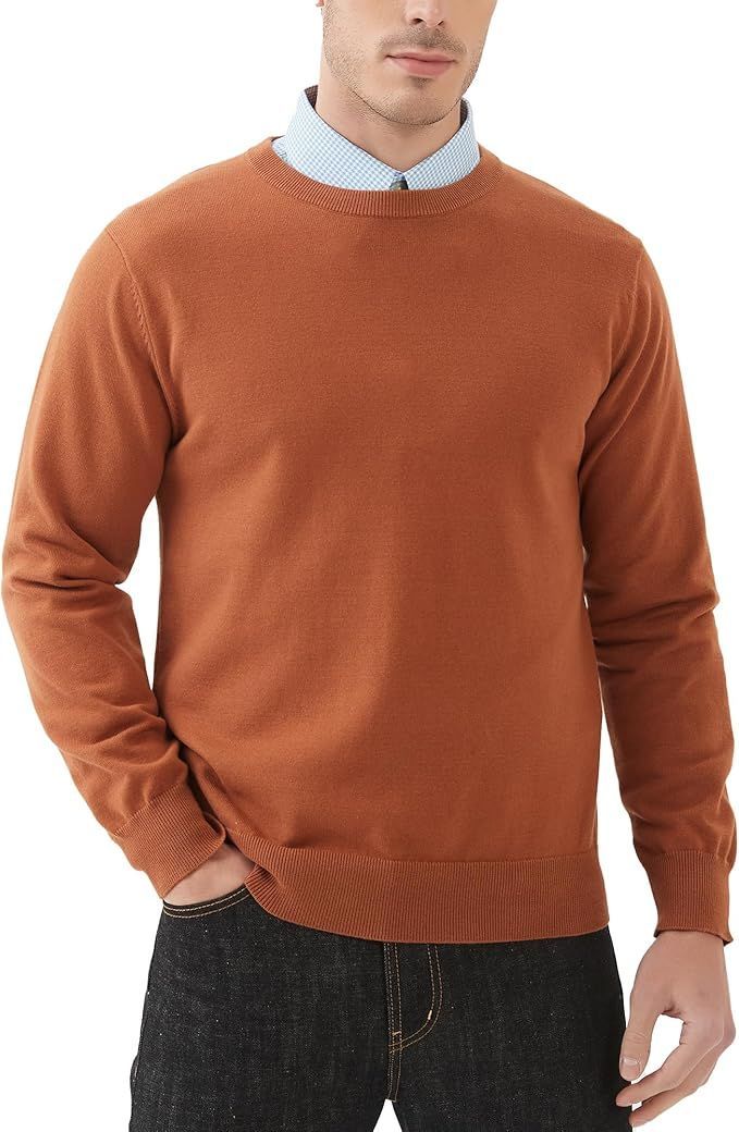 Rust-colored crew neck sweater layered over light blue collared shirt.