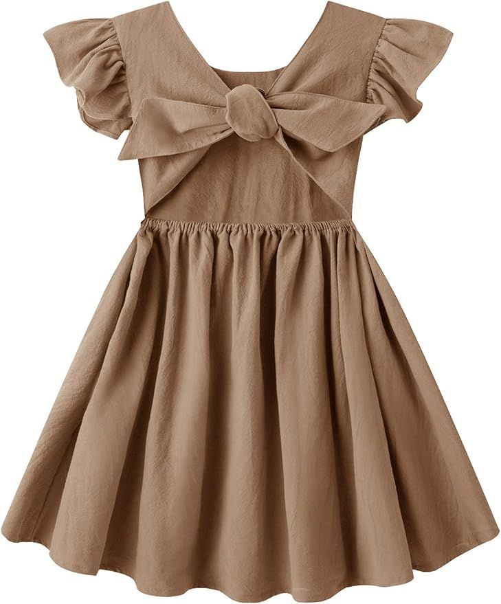 Brown cotton dress with large bow detail and flutter sleeves in a classic A-line design.