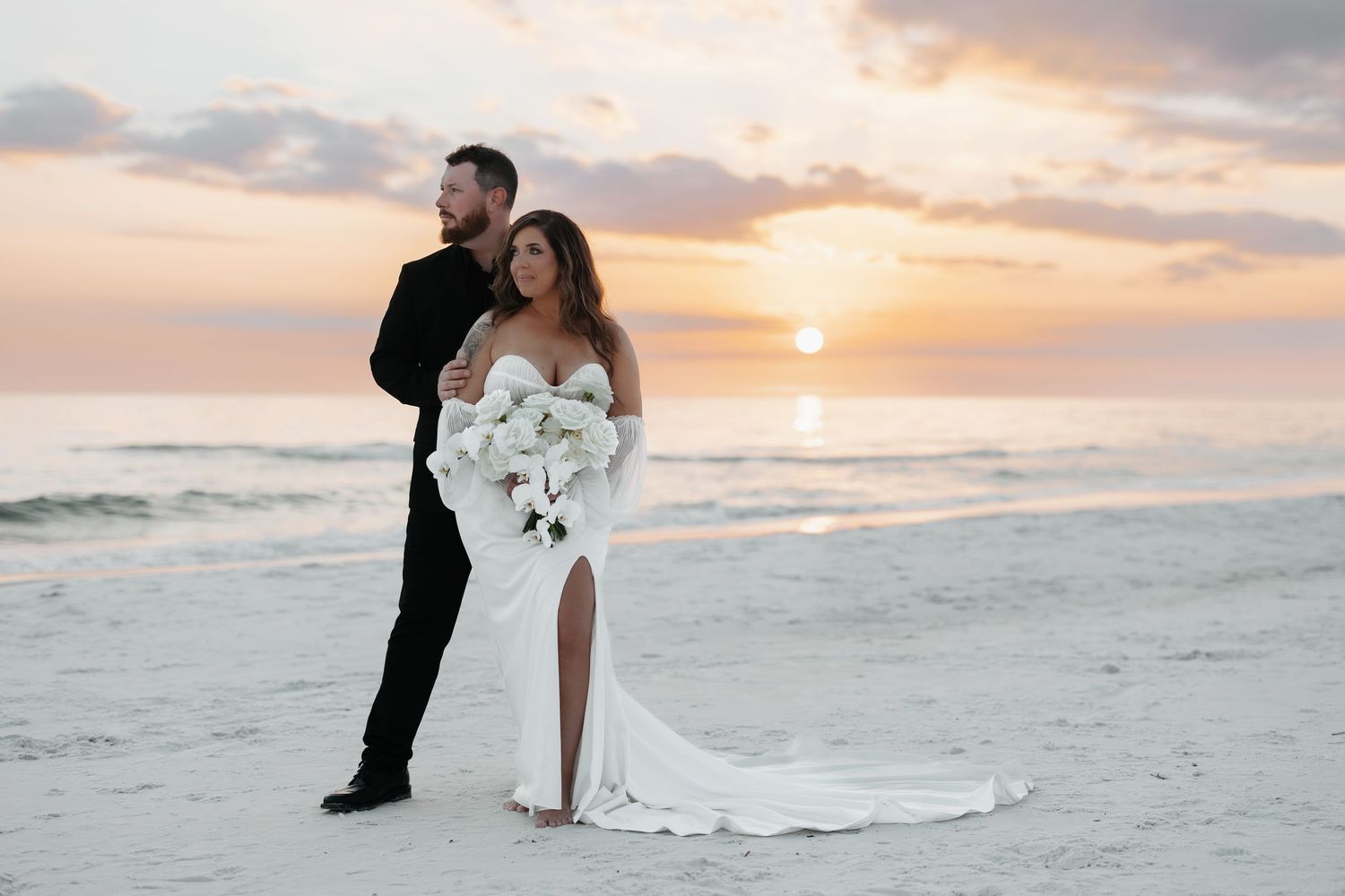 Newlywed couple walking along a scenic beach at sunset with waves crashing in the background.
La Playa Beach & Golf resort