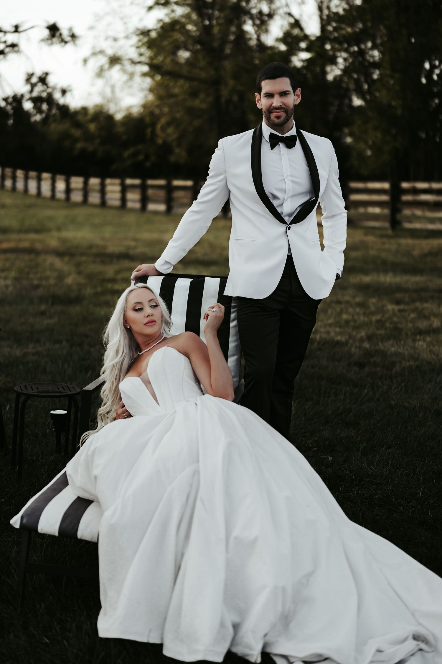 A romantic wedding photo series showing a couple in formal attire posing outdoors at sunset.
The Elia Event Venue