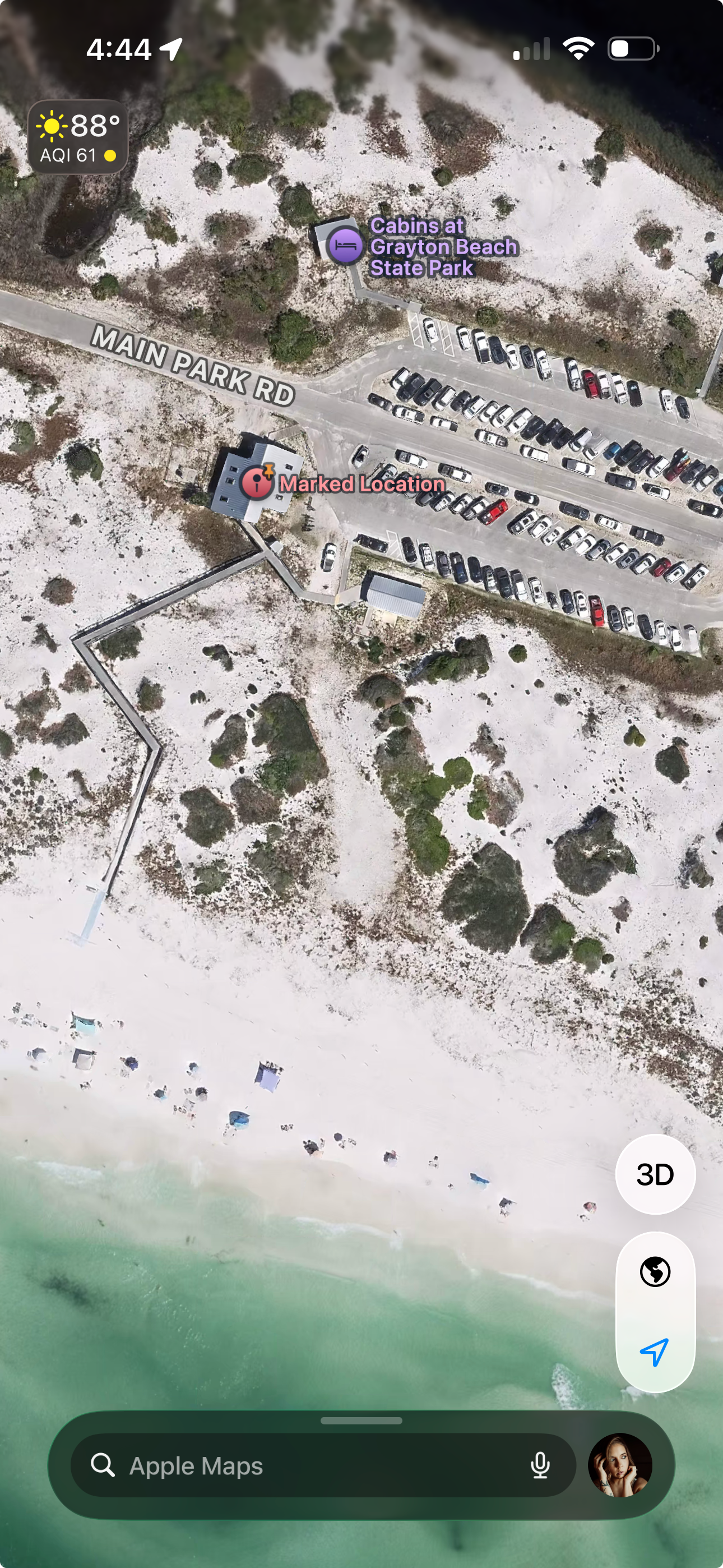 Aerial satellite view of Grayton Beach State Park in Florida showing Main Park Road, beach cabins, parking lot, and emerald Gulf waters.