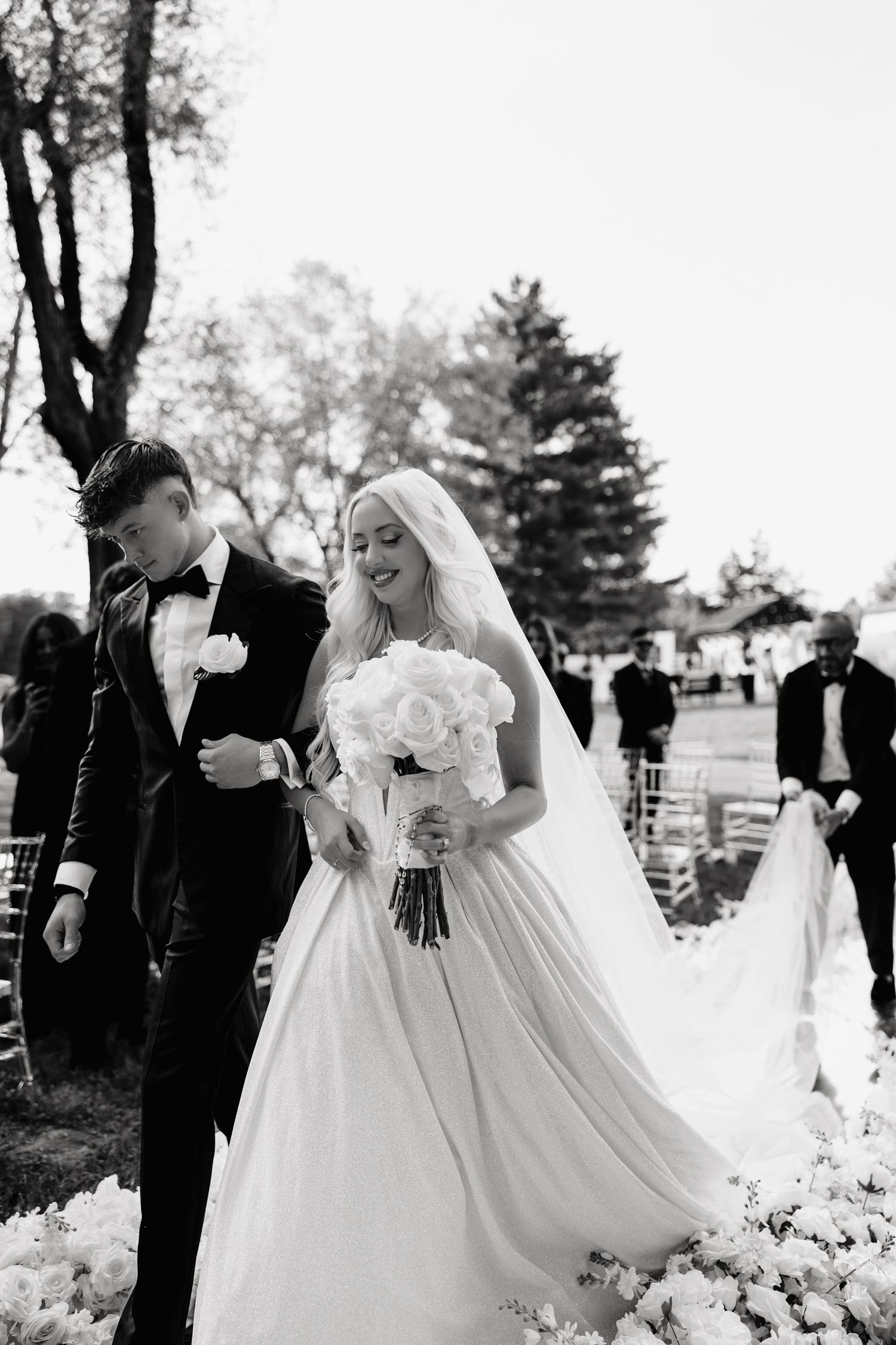Black and white wedding photos show romantic moments between newlyweds in an outdoor garden setting.