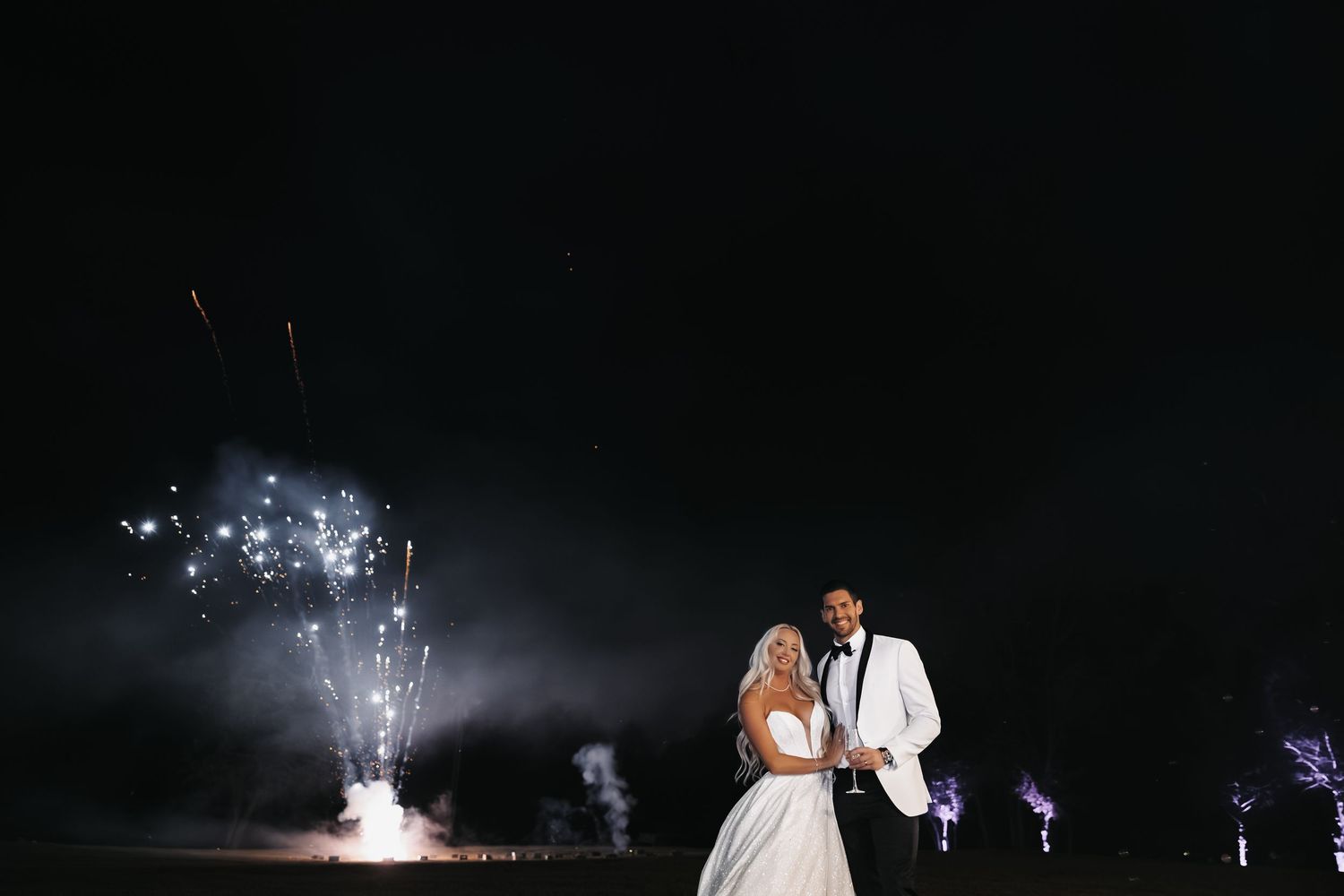 Bride and Groom together on a dark dance floor with fireworks illuminating the night sky behind them.
Vizcaya Museum and Gardens