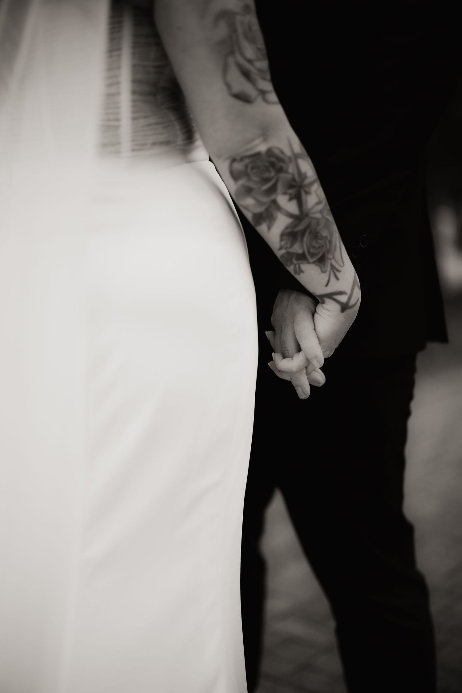 Black and white close-up of a bride and groom dancing together at their wedding reception.