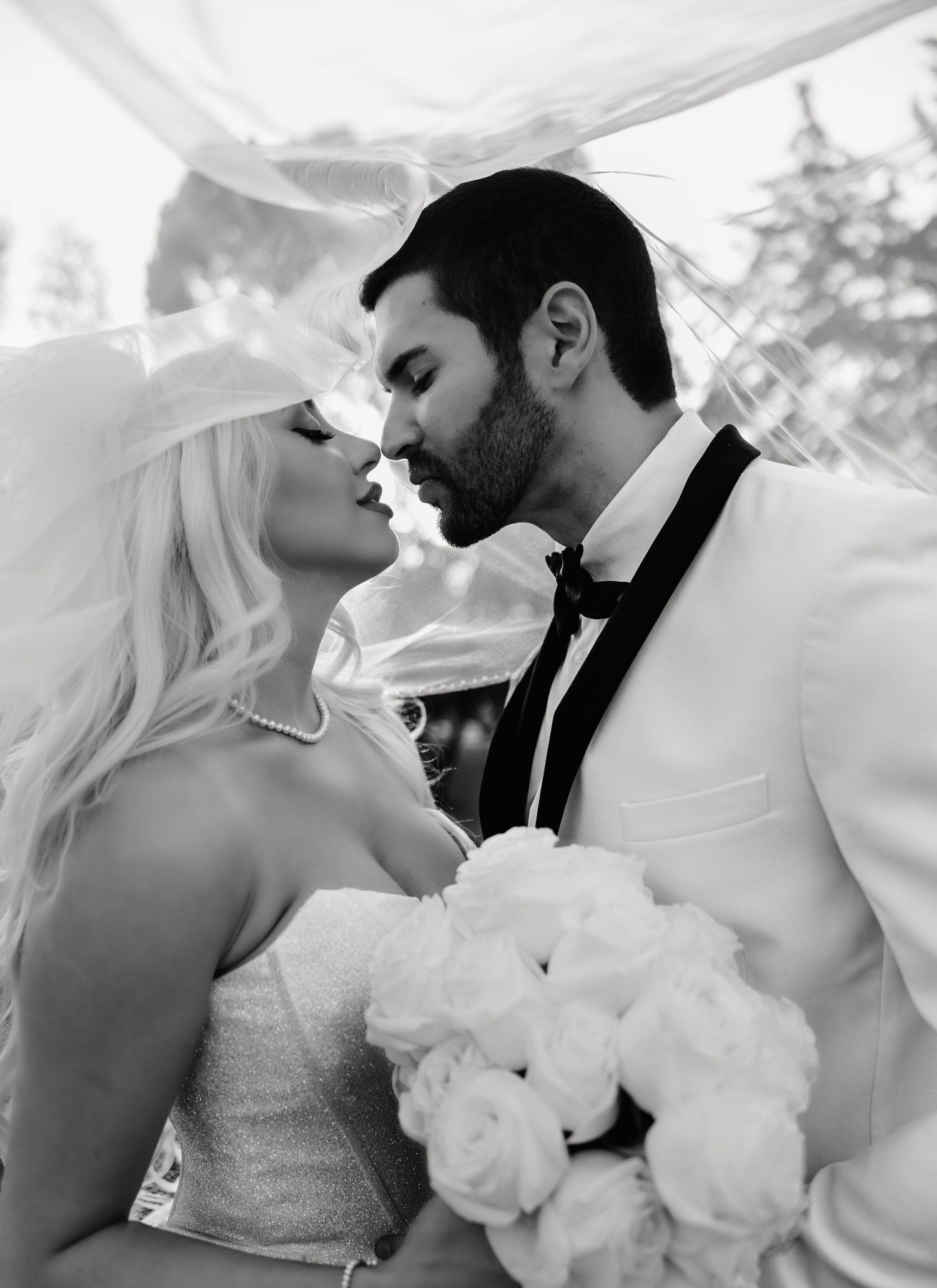 A series of romantic black and white wedding photos showing intimate moments between a bride and groom.