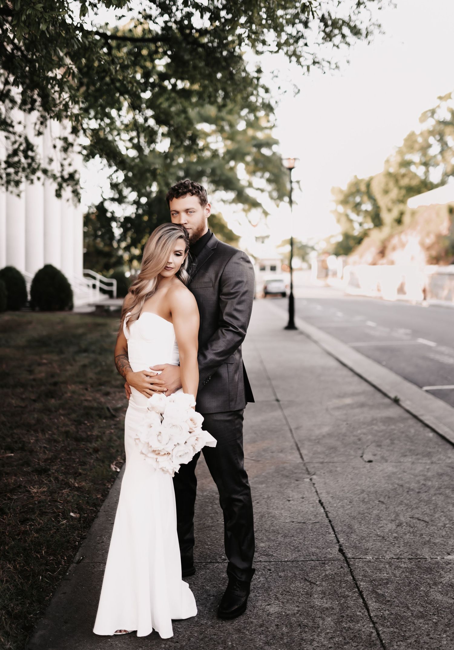 A romantic wedding couple embraces outdoors on a tree-lined pathway in black and white formal attire.
Belle Meade Events - Nashville, Tn