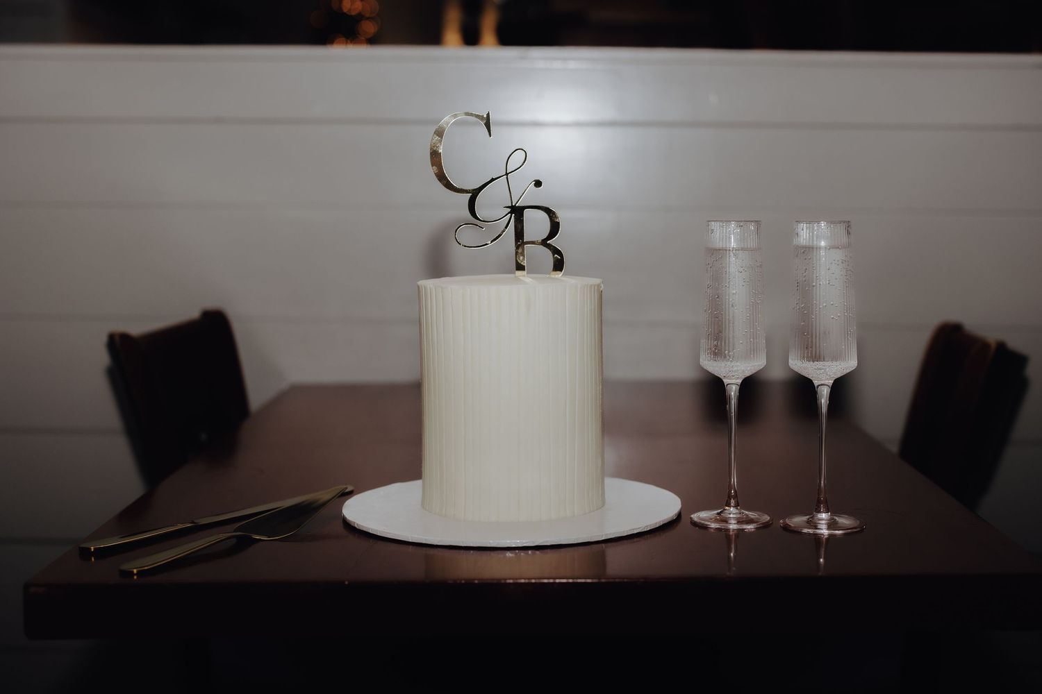 A series of elegant wedding reception details showing white candles, champagne flutes, and decorative elements.