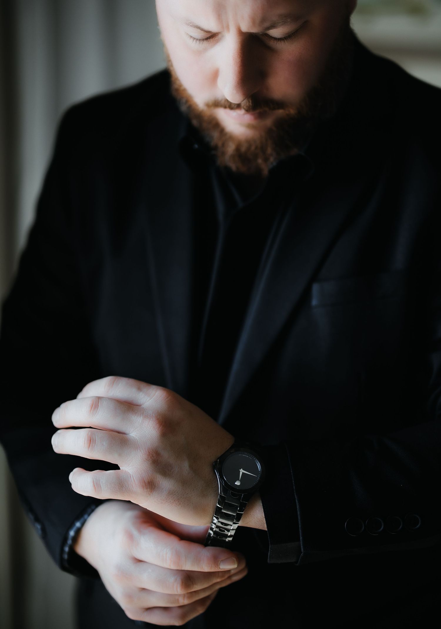 Close-up sequence of hands using a smartwatch and mobile device in low light conditions.