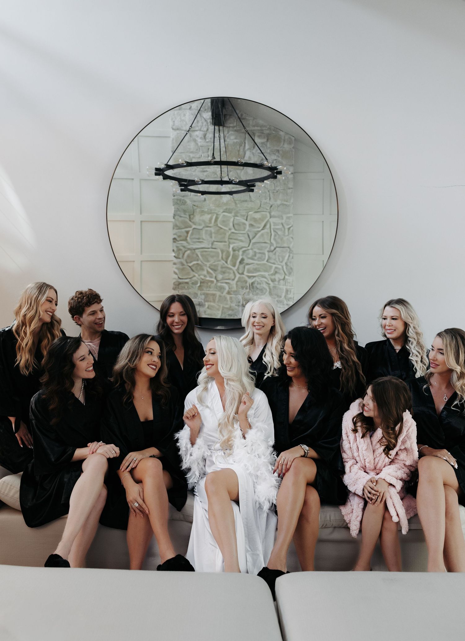 A group in matching black and white outfits pose together on a couch for a stylish boudoir photoshoot session.
Dream Hotel