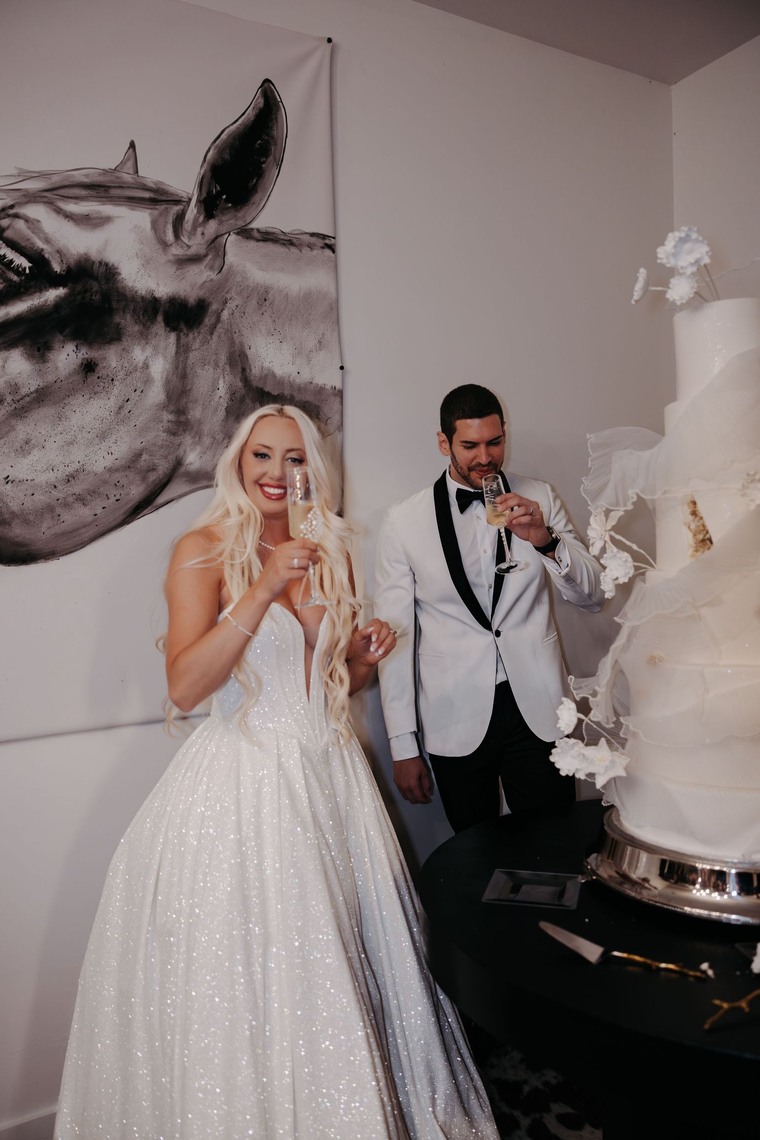 A couple in wedding attire share a playful moment while eating cake together at their reception.
Vizcaya Museum and Gardens
