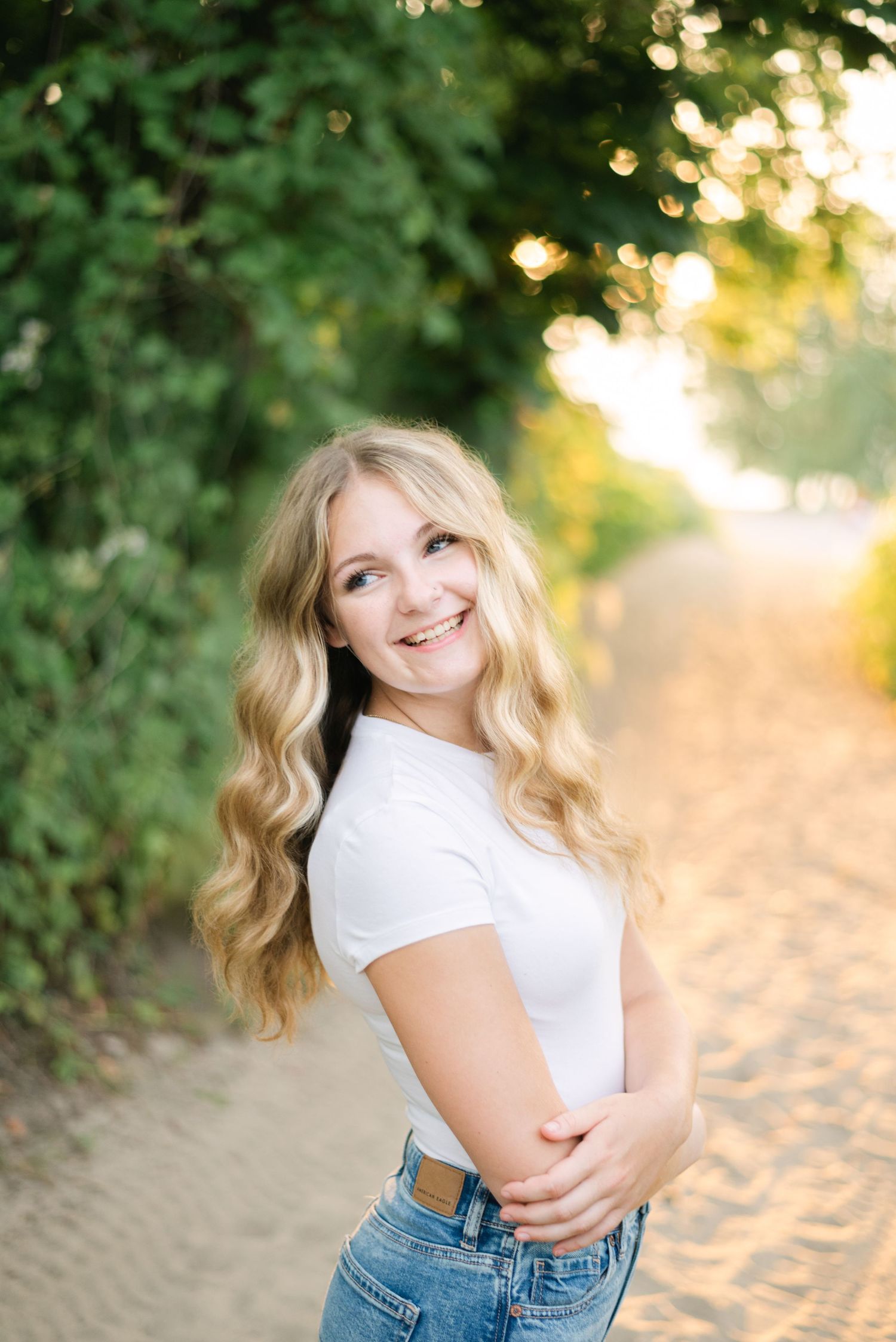Blonde girl smiling over her shoulder at beach